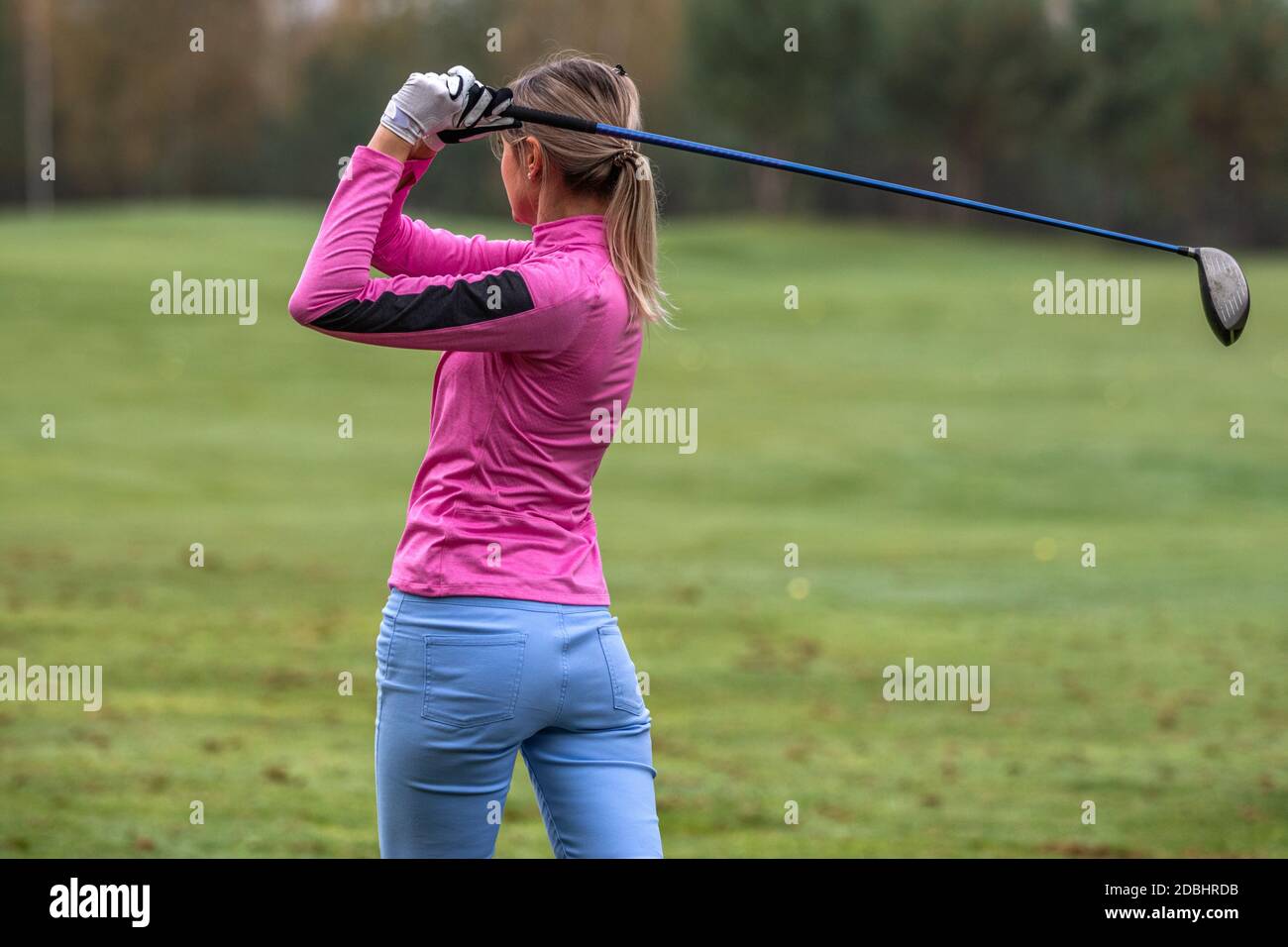 Girl practicing playing golf on the golf course Stock Photo
