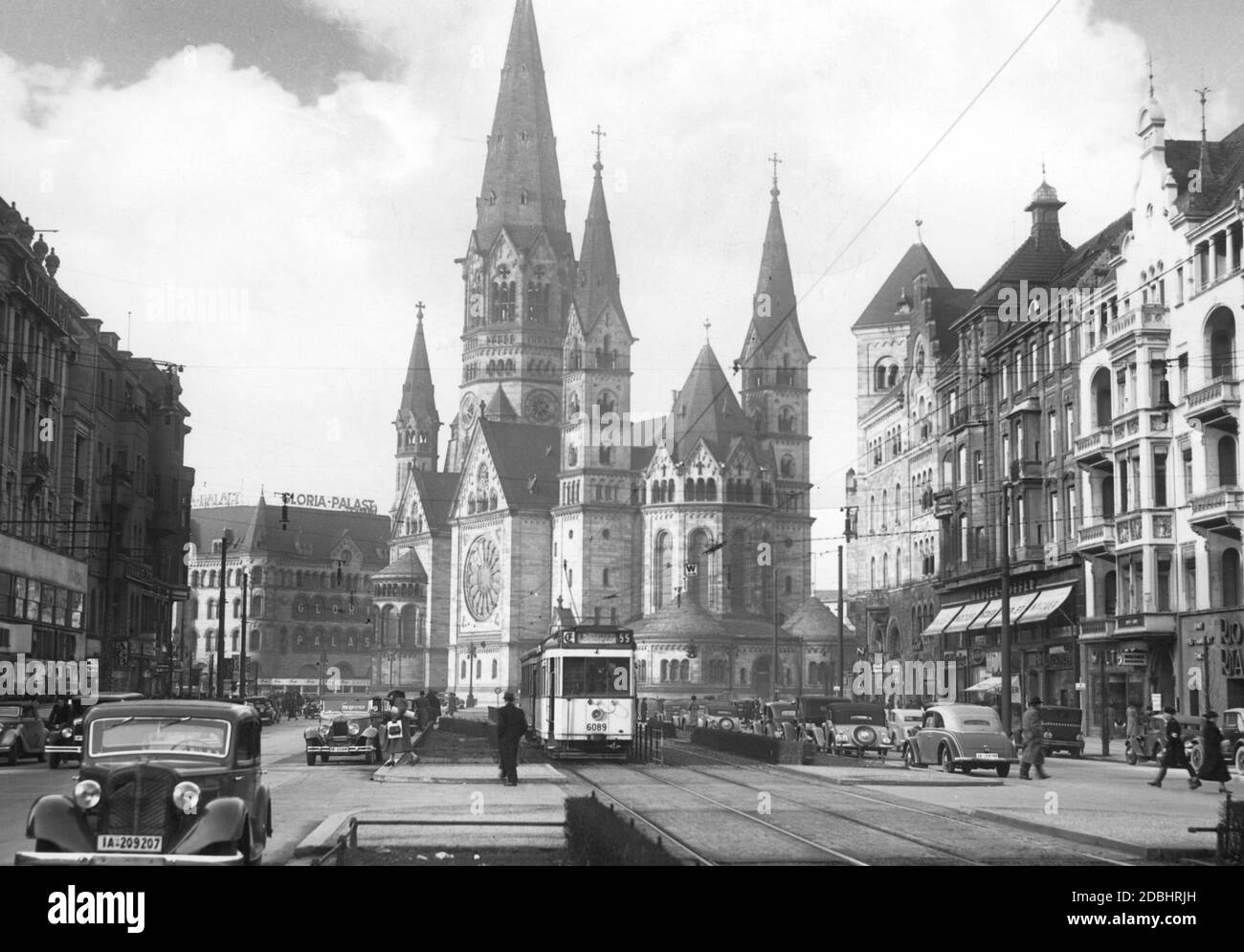 The photo shows the Kaiser Wilhelm Memorial Church in Berlin in 1938, looking out from Tauentzienstrasse in the direction of the church. On the left is the Gloria-Palast in the Romanisches Haus. Stock Photo