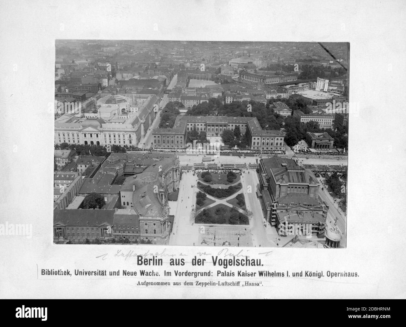 Aerial view from a zeppelin on the street Unter den Linden in 1913. A military parade is just taking place on the street. In the foreground at Bebelplatz is the Alte Palais (or Kaiser-Wilhelm-Palais) the Alte Bibliothek (left) and the Koenigliche Opernhaus (Staatsoper, right). Behind them are the Koenigliche Bibliothek (today State Library), the Humboldt University and the Neue Wache (from left to right). In the background on the right is the Bode-Museum, in front of it the construction site for the Pergamonmuseum. Stock Photo