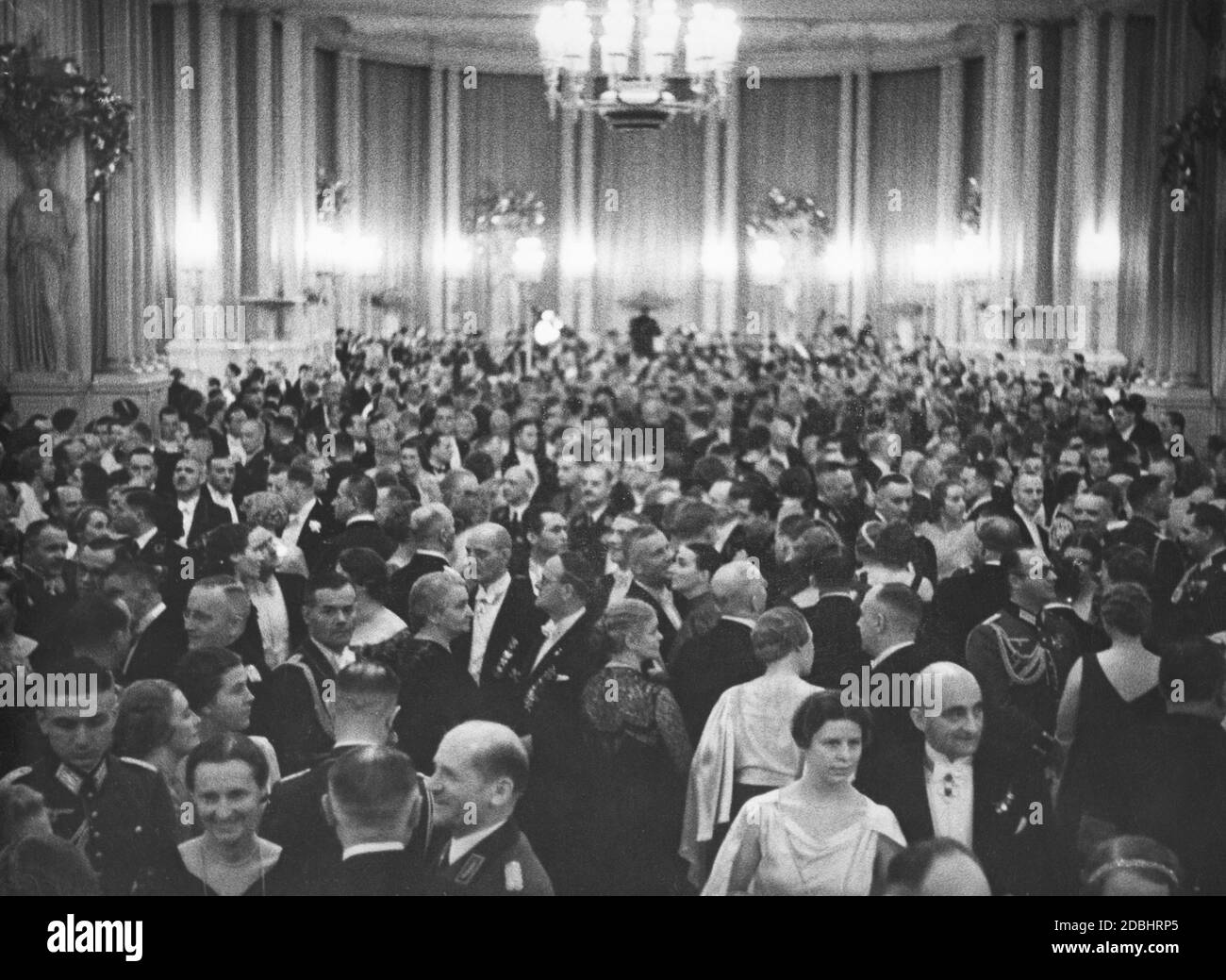On January 12, 1936, the Opera Ball of the Prussian State Theater was held at the Staatsoper Unter den Linden. The photograph shows the guests before the beginning of the event. Stock Photo