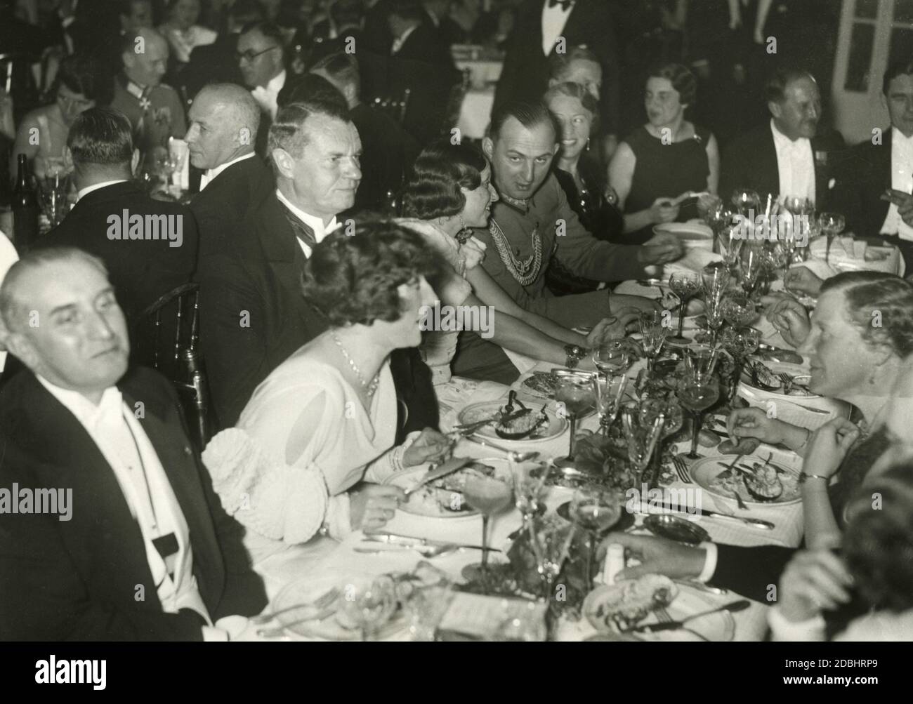 On November 25, 1933 or 1934, the Verein der auslaendischen Presse (Association of Foreign Press) held a ball at the Hotel Adlon in Berlin, which was attended by many diplomats and foreign policy experts. Sitting (from left to right): the Italian ambassador Vittorio Cerruti, Jacqueline Dillais (wife of the French ambassador Andre Francois-Poncet), the Lord Mayor of Berlin Heinrich Sahm, Miss Wearing and Police General and Ministerial Director Kurt Daluege. Stock Photo