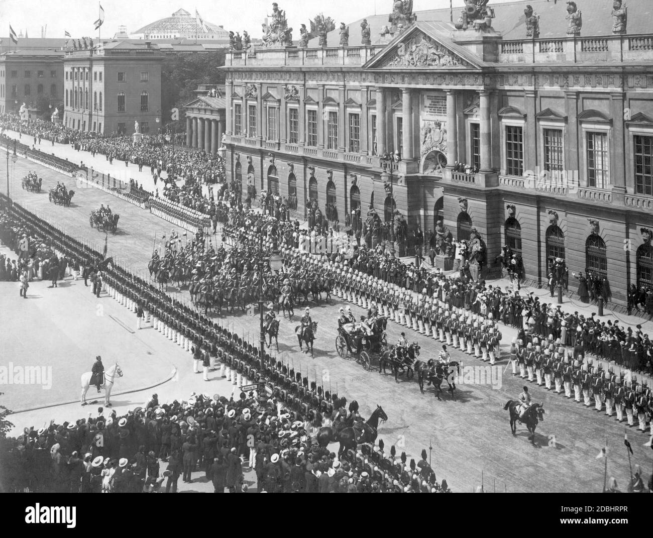 Tsar Nicholas II of Russia rides together with Kaiser Wilhelm II (first carriage in the picture) to the Berlin Palace during a parade on the street Unter den Linden in Berlin on May 22, 1913. On the right is the Zeughaus, left beside it the Neue Wache and on the left the Humboldt-University. The occasion of the Tsar's trip to Germany was the wedding of Ernest Augustus of Hanover with Victoria Louise of Prussia (daughter of the Emperor). Stock Photo