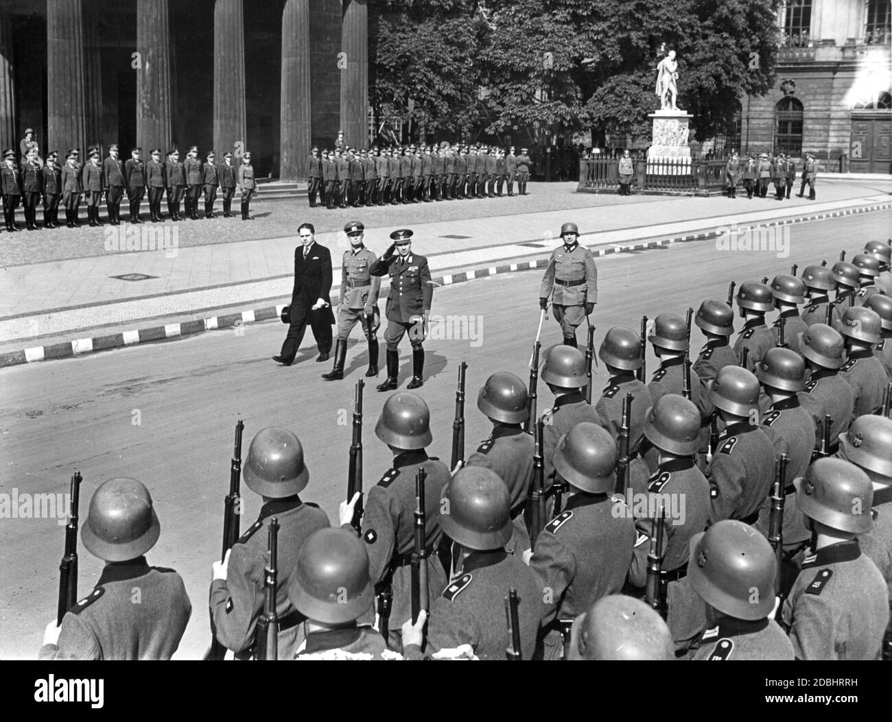 On Thursday afternoon, August 22, 1940, the Slovakian Minister of Defense Ferdinand Catlos (center, saluting) laid a wreath at the memorial on Unter den Linden in Berlin. The picture shows the inspection of the honor company of the Wehrmacht. To the left of Catlos, the city commandant of Berlin Ernst Seifert (center) and the Slovakian envoy in Berlin Matus Cernak are walking. Stock Photo