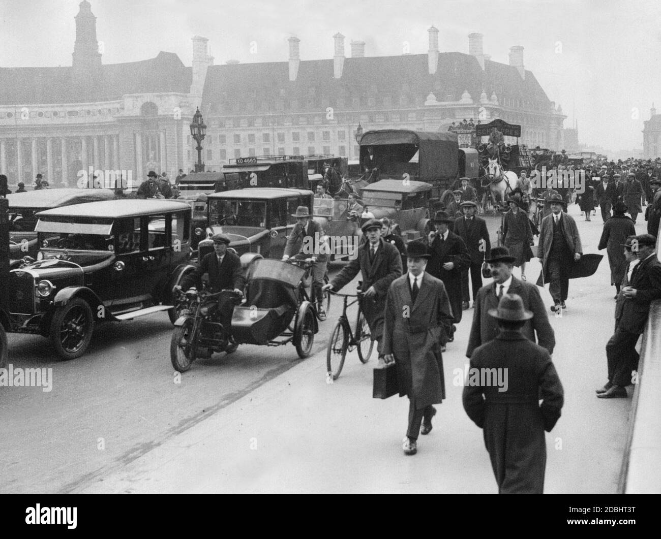 Passers-by cross the Westminster Bridge on foot on their way to work during the local traffic strike. In the background is the County Hall. (undated photo) Stock Photo