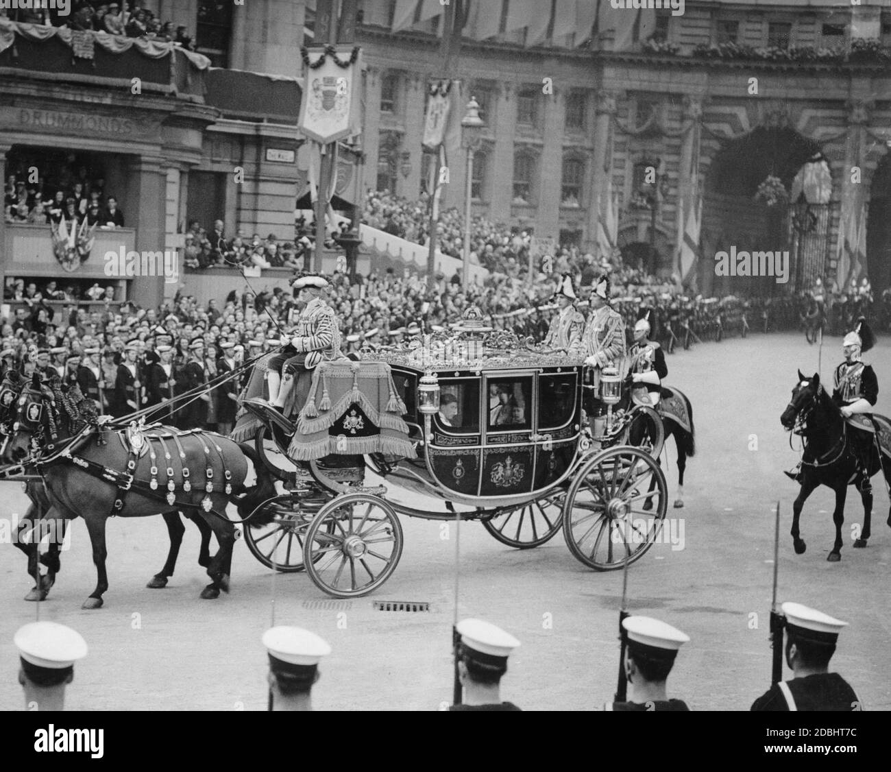 The carriage in which Viscount Lascelles, the King's page of honour and nephew, Princess Elizabeth (right) and Princess Margaret Rose, drive through Trafalgar Square towards Westminster Abbey for the coronation celebrations in honour of King George VI. Stock Photo