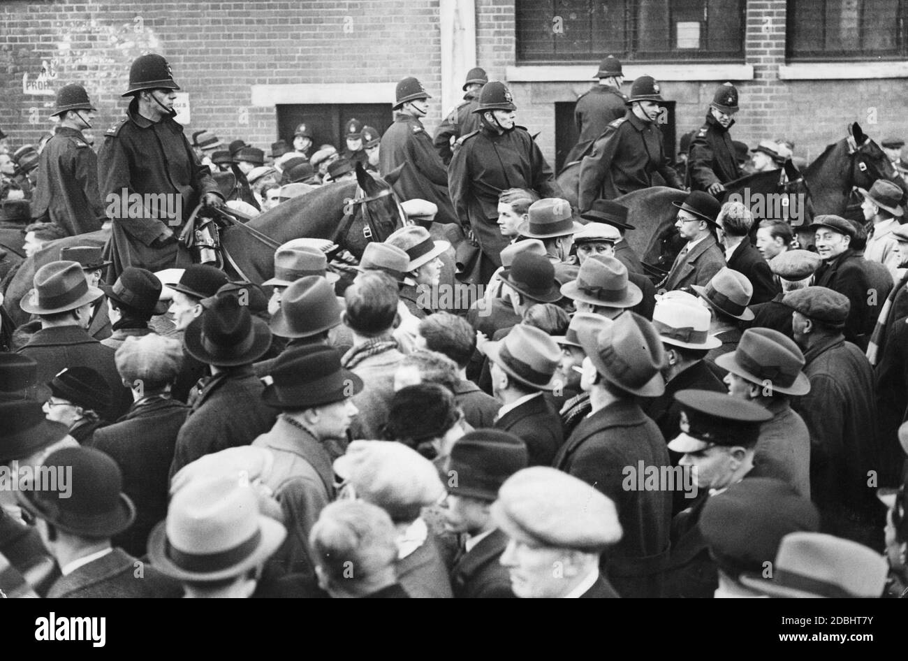 Mounted policemen control a crowd of soccer fans in front of the White Hart Lane soccer stadium in the London district of Tottenham on the occasion of the international soccer game England vs. Germany (3:0). Stock Photo