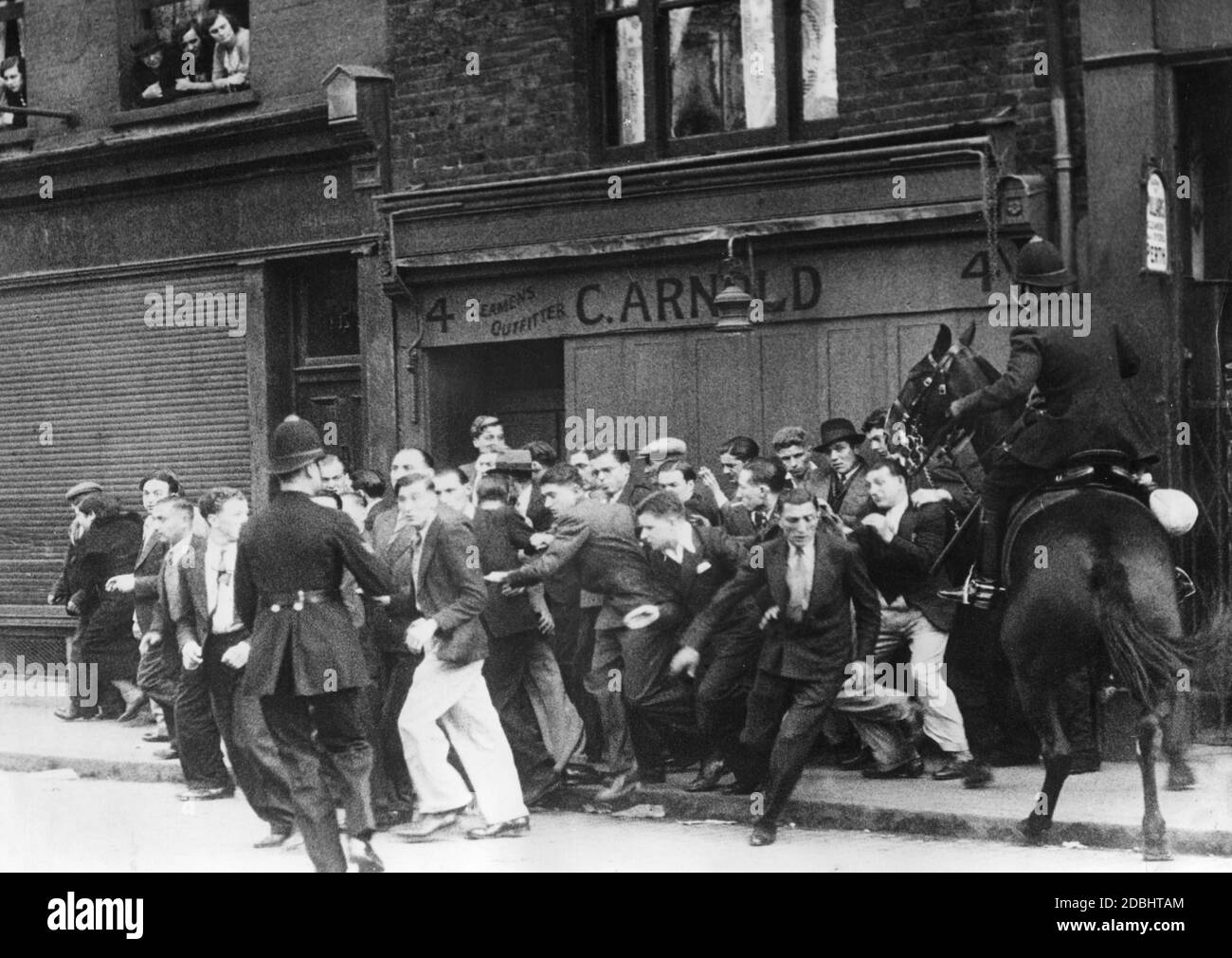 "Clashes between demonstrators and police in London. On the occasion of a planned march of the ""British Union of Fascists"" (BUF) through Whitechapel, numerous counter-demonstrators had gathered in London." Stock Photo