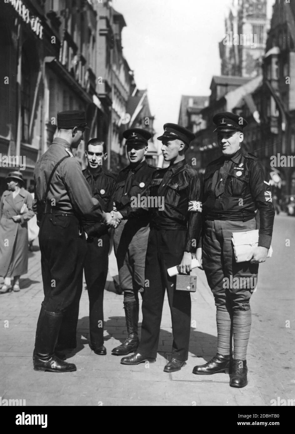 'Members of the ''Imperial Fascists Legion'' came to Nuremberg to attend the Nazi Party Congress in Nuremberg as guests. A member of the SS greets them in the Old Town of Nuremberg.' Stock Photo
