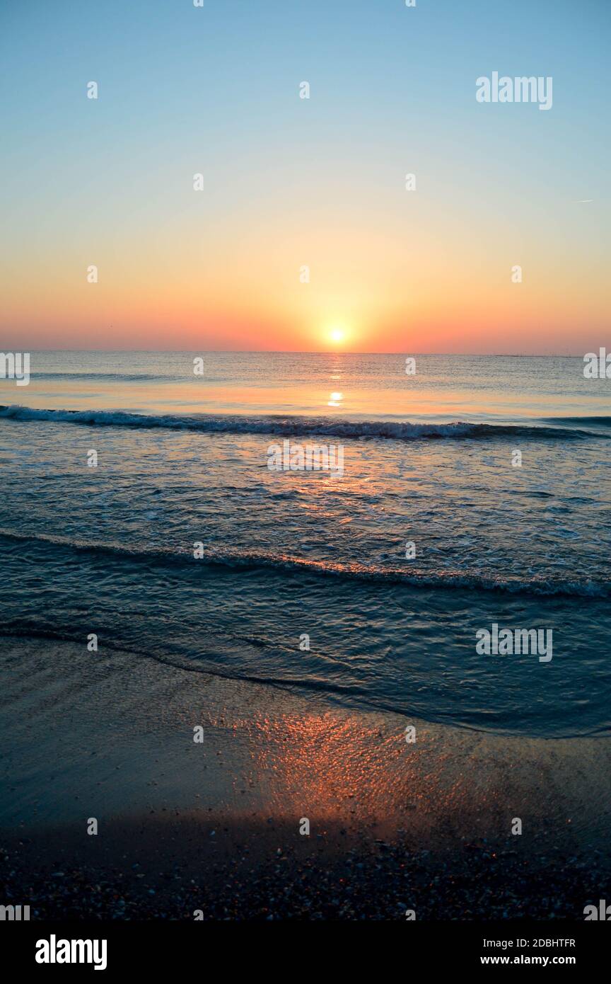 Beautiful summer landscape, sunset at the beach, sparkly sand and waves ...