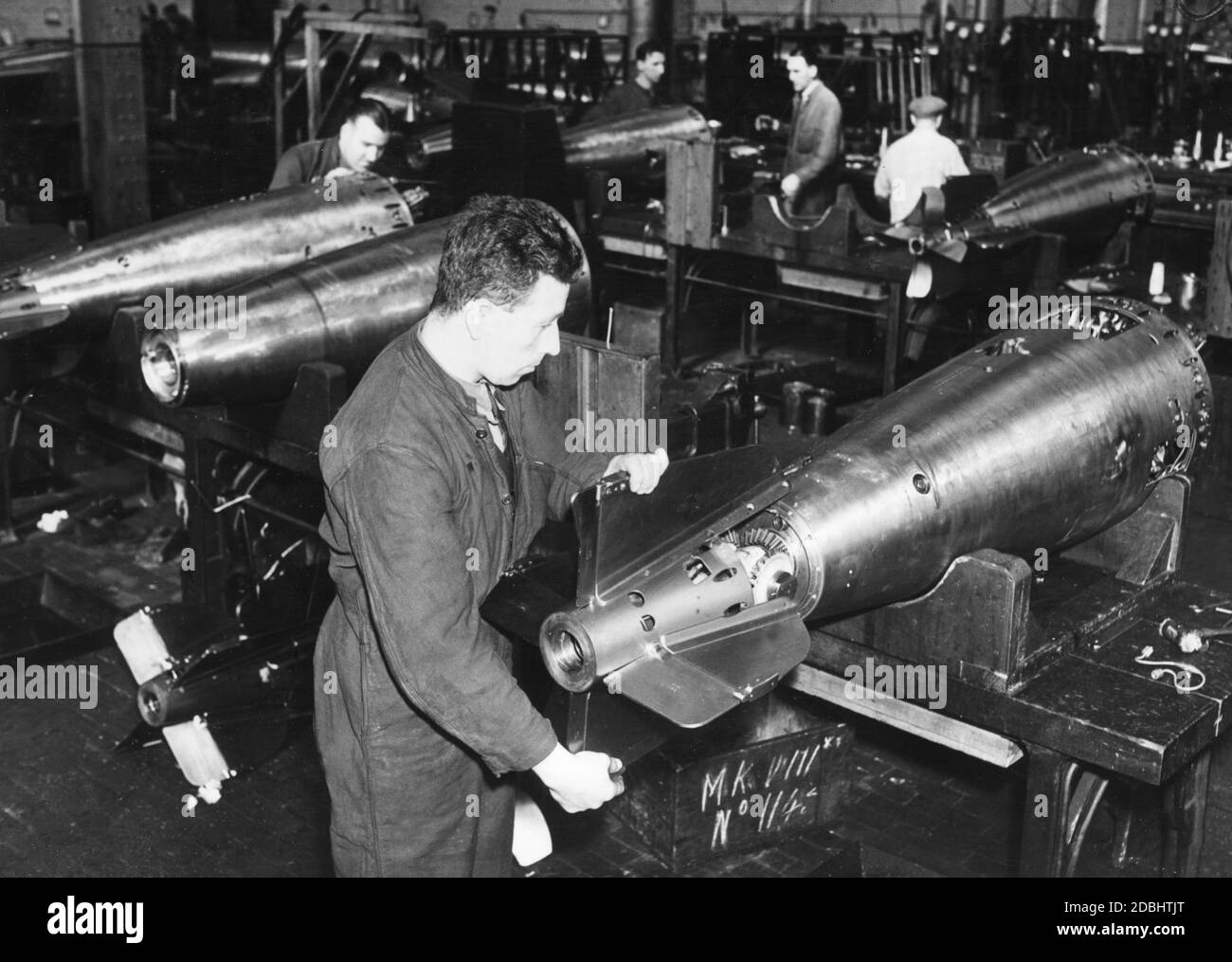 Workers producing torpedoes in a British armaments factory. Stock Photo