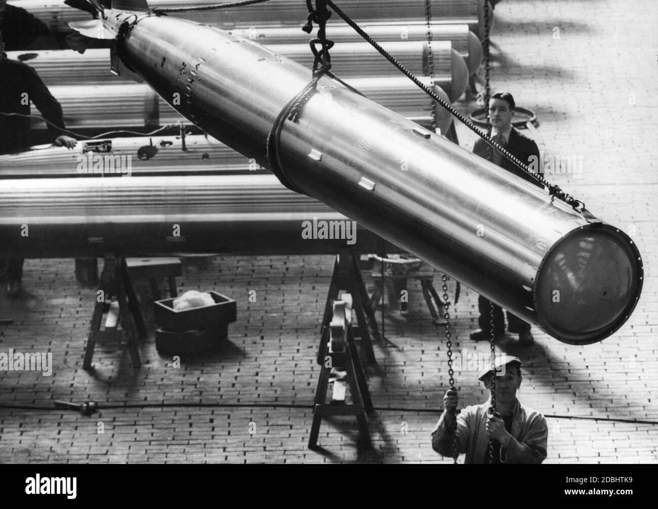 Worker involved in the production of torpedoes in a British armaments factory. Stock Photo