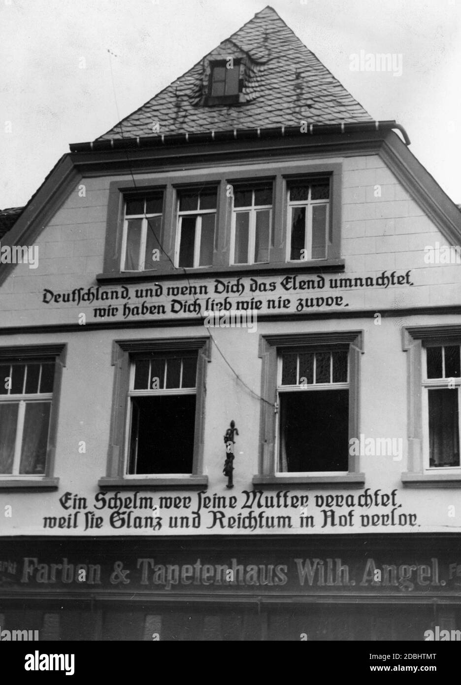 'The Farben & Tapetenhaus Wilh. Angel is one of several houses in St. Wendel, which citizens have inscribed with verses, which are directed toward the fight against the German population of the Saar. Above: ''Germany, and if misery falls upon you, we love you as never before''. Below: ''A rascal who despises his mother because she lost her splendour and wealth in adversity''.' Stock Photo