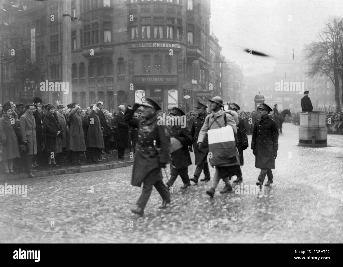 Soldiers of the International Troops in Saarland with the tricolour. In the background, the Hotel Terminus. Stock Photo