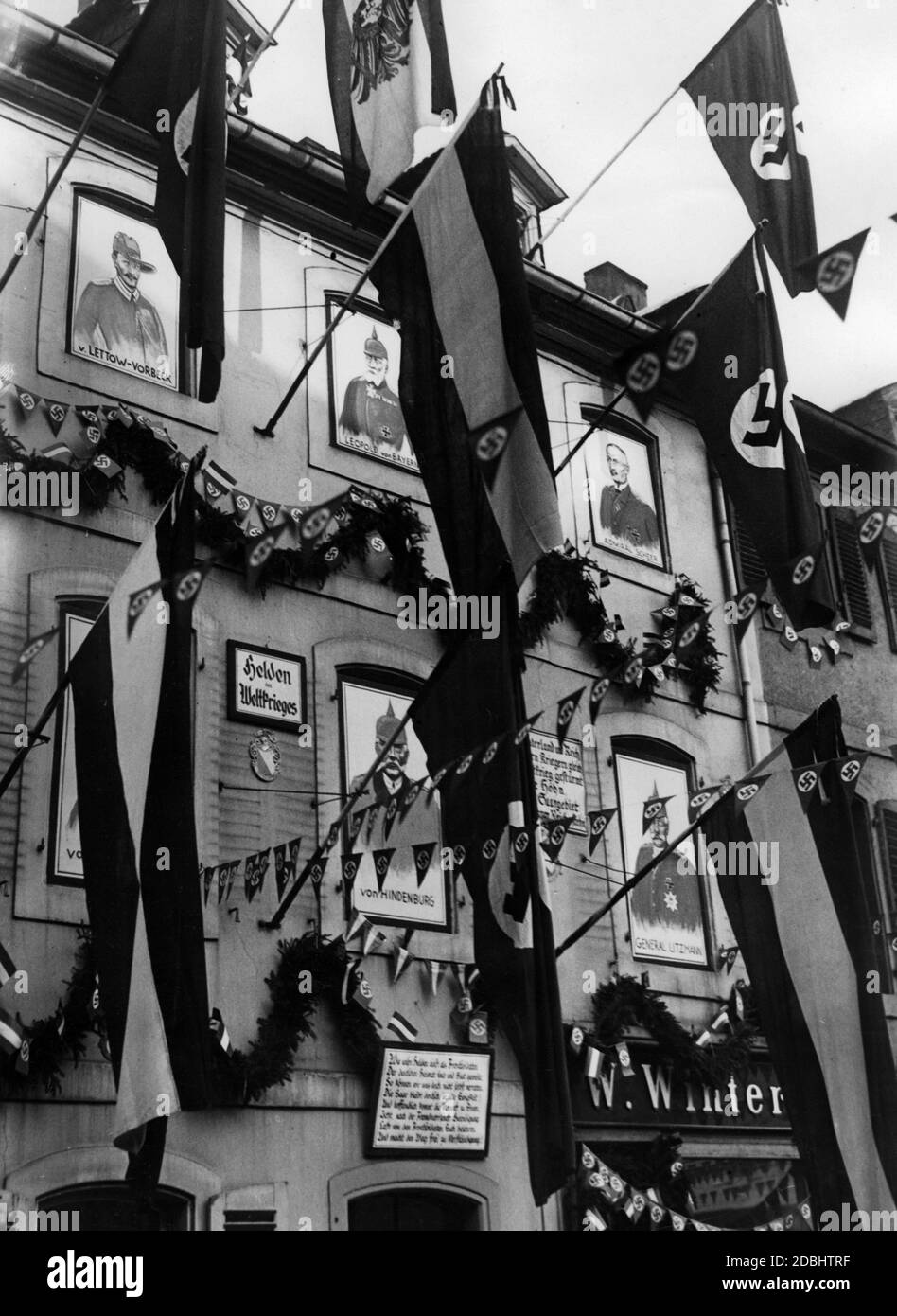 'In the days following the referendum on the return of the Saar region to the German Reich, the streets of Saarbruecken's old town are decorated with flags, banners and fir sprigs. In addition, in the windows of these houses are displayed portraits of the ''Heroes of the World War''. Paul von Lettow-Vorbeck, Prince Leopold of Bavaria, Admiral Reinhard Scheer, Paul von Hindenburg, General Karl Litzmann.' Stock Photo