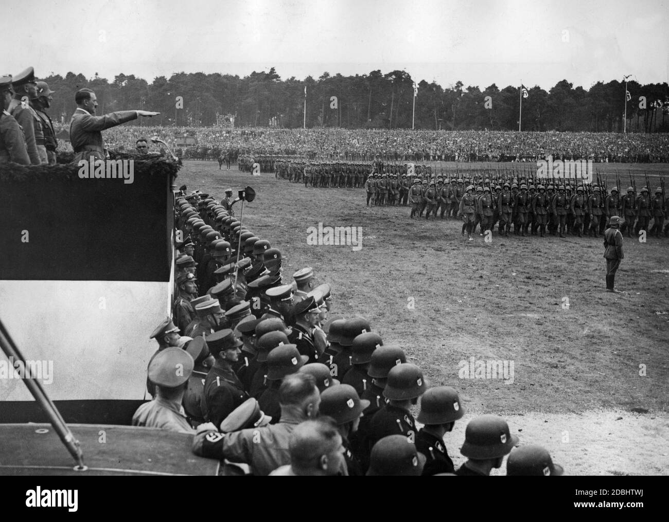 On the Zeppelin Field in Nuremberg, Adolf Hitler ( left behind him stands Werner von Blomberg) takes the salute of the passing Wehrmacht troops. Stock Photo