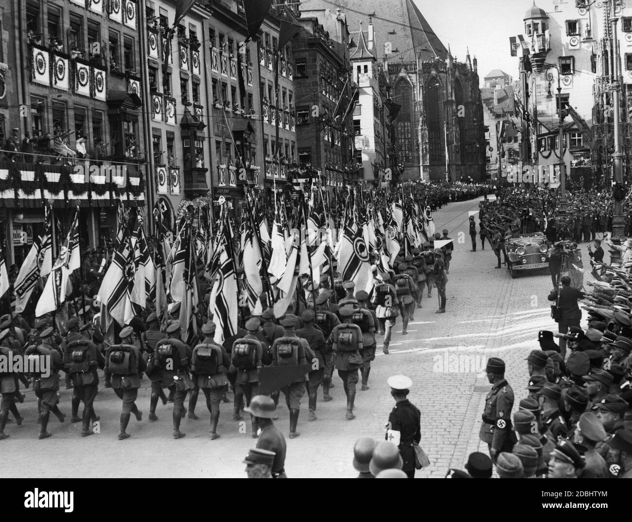 Adolf Hitler, in a Mercedes, takes the salute of the Stahlhelm flags on ...