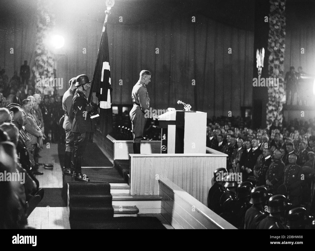 Viktor Lutze, Chief of Staff of the SA, gives a speech at the opening ceremony of the Nazi Party Congress in Nuremberg's Luitpoldhalle. On the left, Hermann Goering. Stock Photo