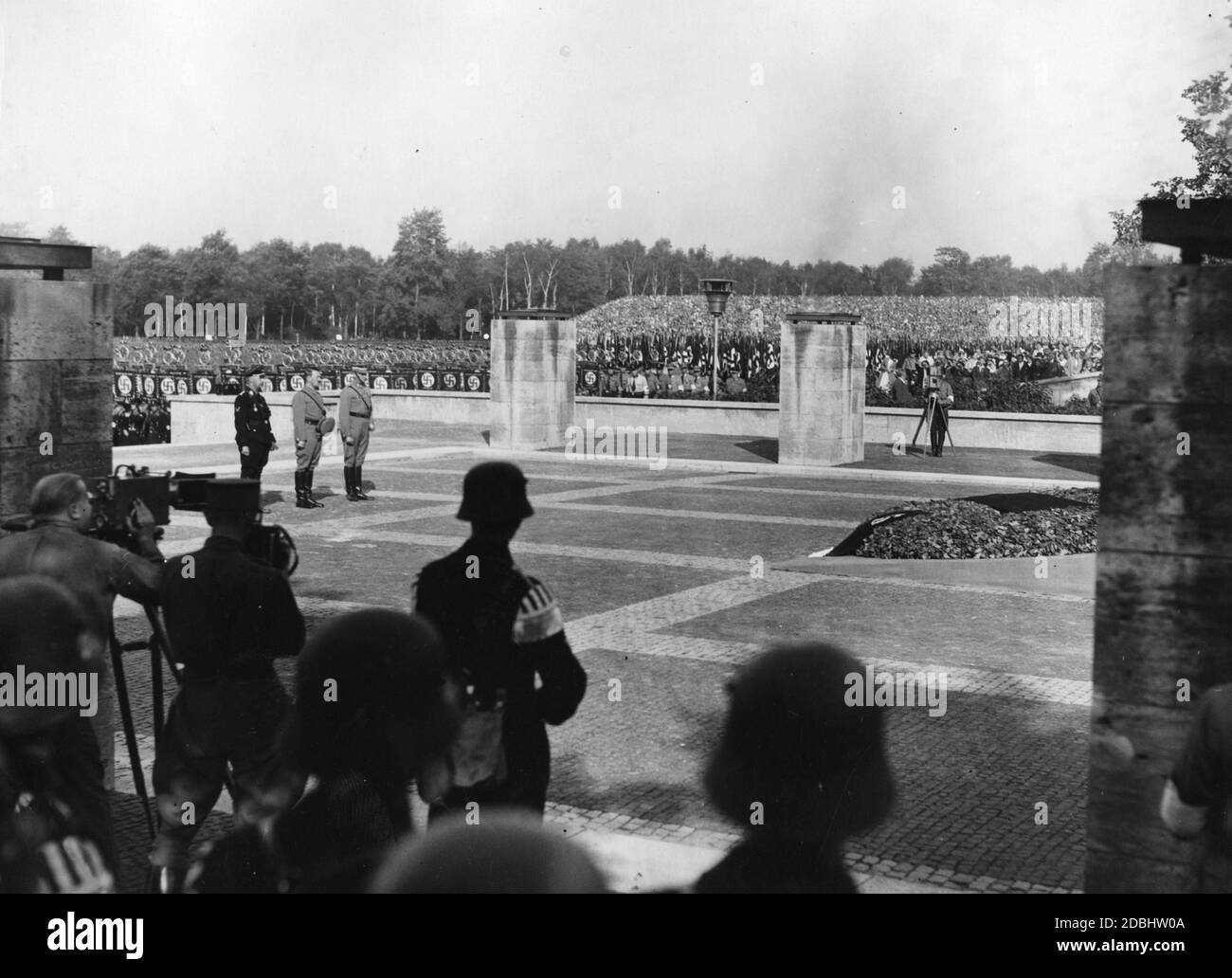 During the Nazi Party Congress in Nuremberg (from left) Heinrich Himmler, Adolf Hitler and Viktor Lutze together with formations gathered in the Luitpoldarena commemorate the fallen of the Beer Hall Putsch in front of the Hall of Honour for the Fallen of the First World War, designed by Fritz Mayer. On the left and right are camera teams. Stock Photo