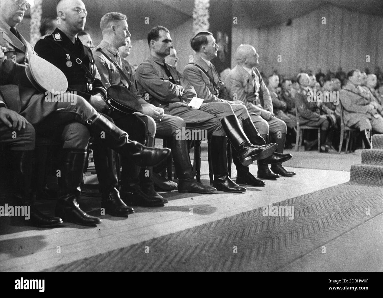 The party congress of the NSDAP is opened in the Luitpoldhalle on the Nazi Party Rally Grounds in Nuremberg. From left: Reich Treasurer Franz Xaver Schwarz, Reich Leader SS Heinrich Himmler, Chief of Staff of the SA Viktor Lutze, Rudolf Hess, Adolf Hitler, Gauleiter Julius Streicher. On the right, Hermann Goering. Stock Photo