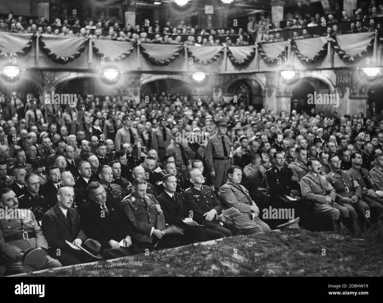 View of the first row of spectators at the cultural conference of the NSDAP in Nuremberg's Apollo Theater, where Alfred Rosenberg and Adolf Hitler give speeches and the Reich Symphony Orchestra presents a musical performance. 1st row from left: Bernhard Rust, Baron Paul Eltz von Ruebenach, Franz Guertner, Franz Seldte, Johann Ludwig Graf Schwerin von Krosigk, Colonel General Werner von Blomberg, Hermann Goering, Adolf Hitler, Alfred Rosenberg, Rudolf Hess, and the Chief of Staff of the SA Viktor Lutze. In the 2nd row behind Blomberg is Erich Raeder, to the left Werner von Fritsch and Walter Stock Photo