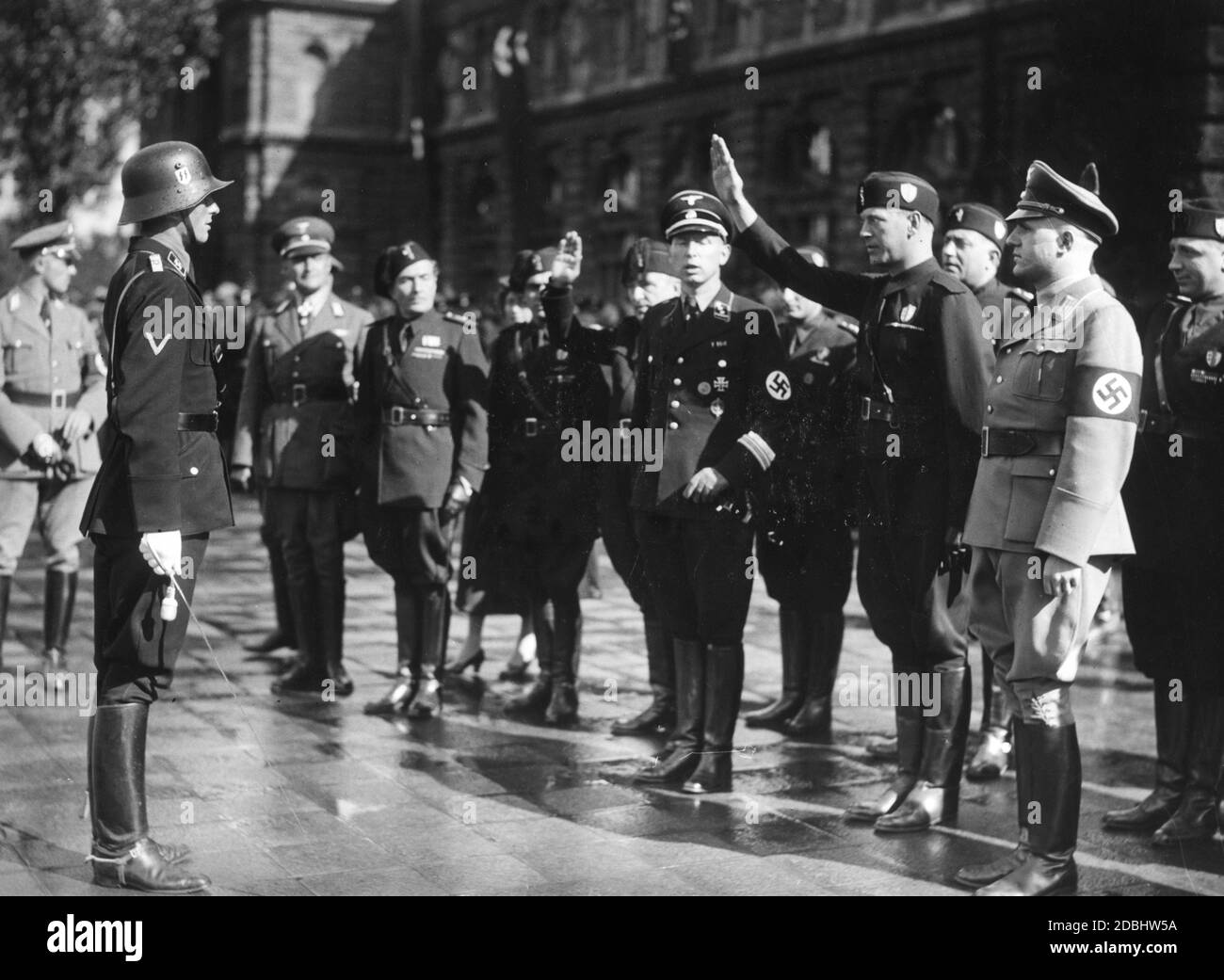 'For the reception of an Italian delegation of fascists, a guard of honour of the SS-Standarte ''Deutschland'' has marched in front of the Nuremberg Main Station, here the officer of the guard of honour when reporting.' Stock Photo