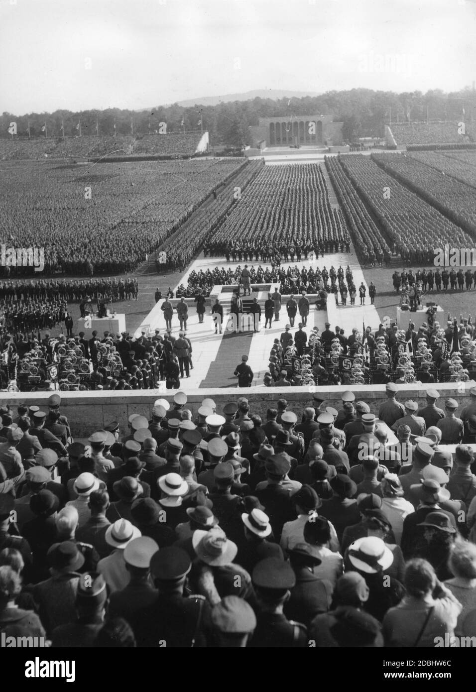 Adolf Hitler gives a speech on the Day of the SA, SS and NSKK in the Luitpoldarena on the Nazi Party Rally Grounds. In the background, the Ehrenhalle (Hall of Honour). Stock Photo