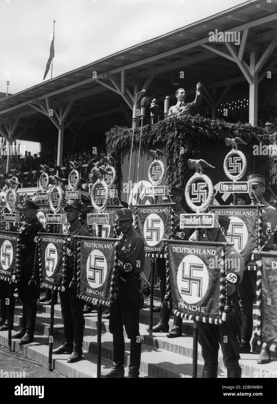 Reichsminister Joseph Goebbels during his speech on the Day of the Gau Kurmark in the airship port of Potsdam. In front of the speaker's desk SA members hold the SA standards of Frankfurt Oder, Grossbeeren, Oberbarnim, Ostmark, Brandenburg, Uckermark and others. Stock Photo