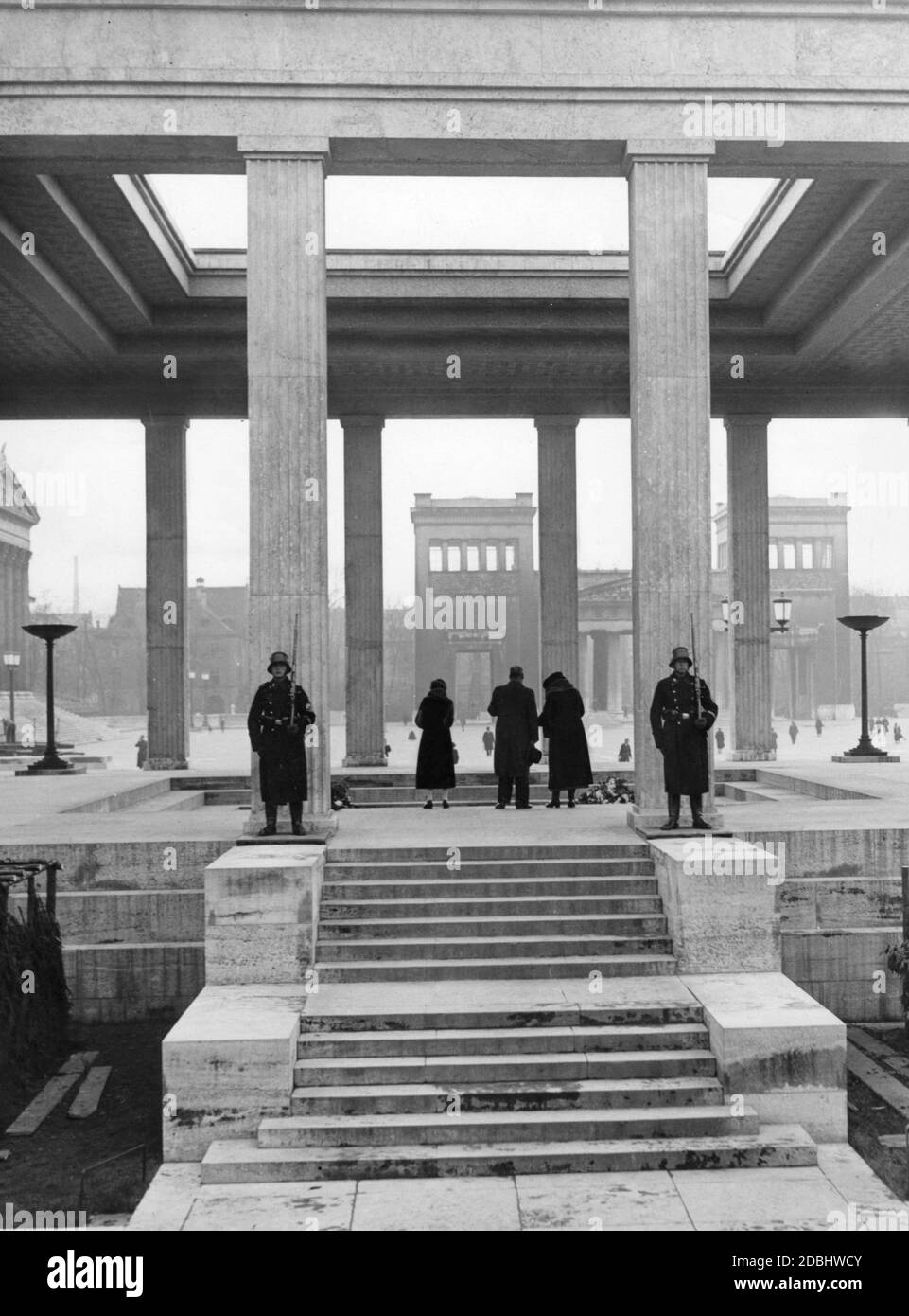 One of the two Ehrentempel at Munich's Koenigsplatz. SS guards stand guard at the entrance. In the background, the Propylaea. Stock Photo