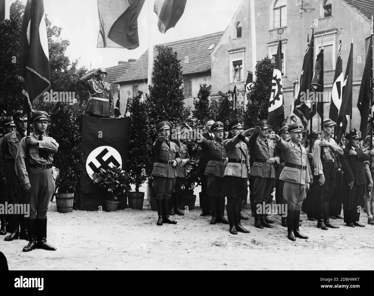 'The Air War School Wildpark Werder is ceremonially received in its new location Werder. At the lectern, the commander of the Air War School, Lieutenant Major Floerke, and in the foreground on the right, the District President Fromm Potsdam. The ''Deutschlandlied'' is being sung.' Stock Photo