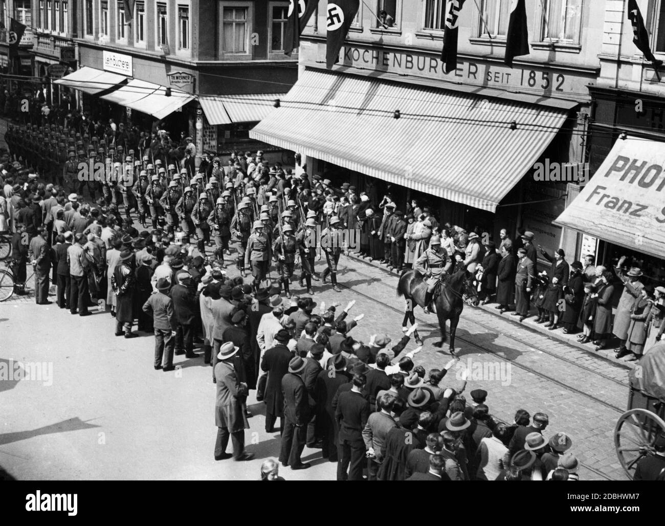 A German Infrantry troop marches through the streets of Heidelberg during a parade. Presumably the troops have just reached their new garrison town Heidelberg. Stock Photo