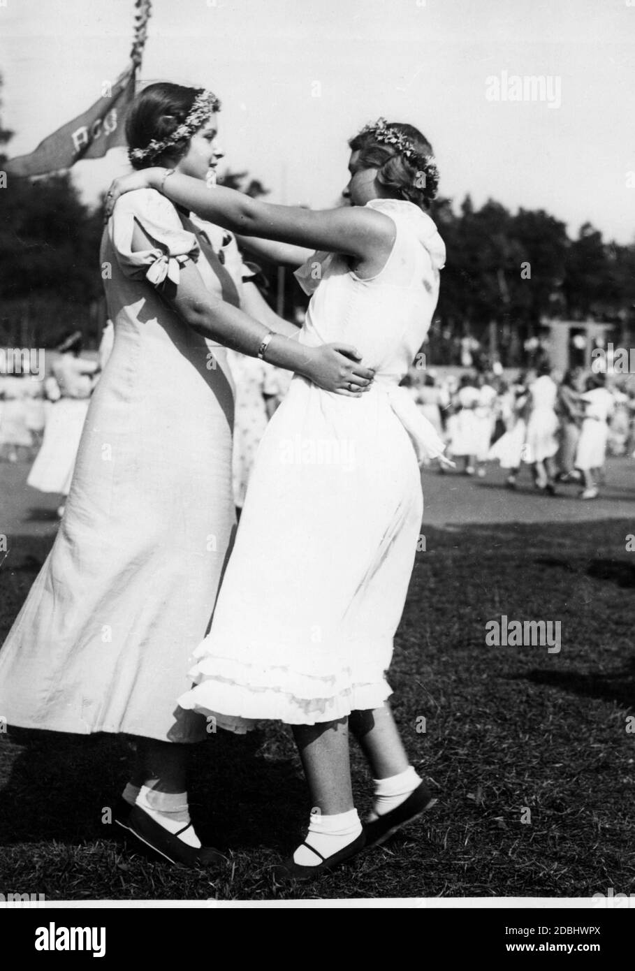 Berlin schools rehearse in the SCC-Stadion for the Day of German Nationality on 16.09.1934. Here a view of dancing schoolgirls. In the background is a flag of the VDA. Stock Photo