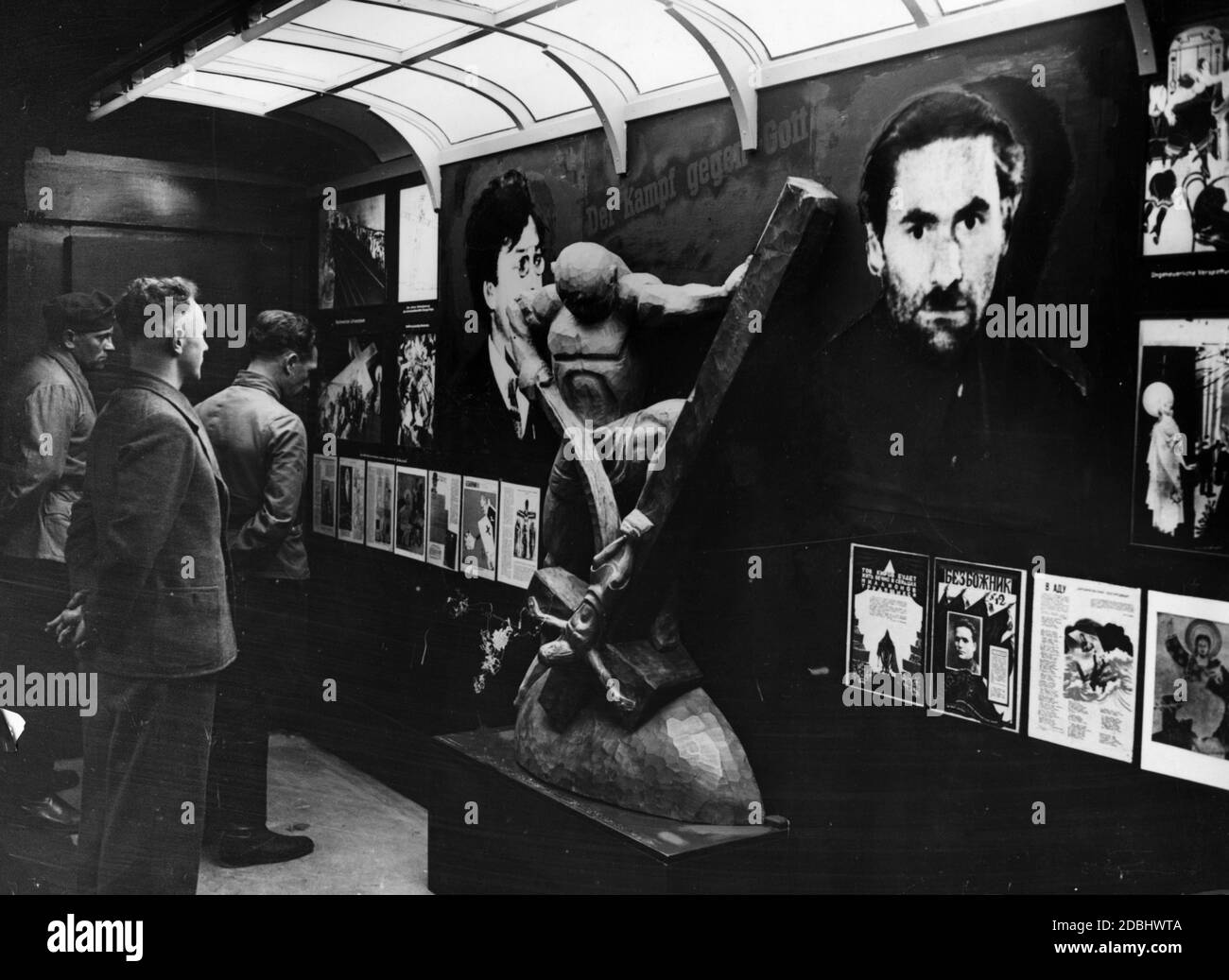 'View of the exhibition ''Das politische Deutschland'' (Political Germany). The picture shows the sculpture of a man, who damages a cross.' Stock Photo