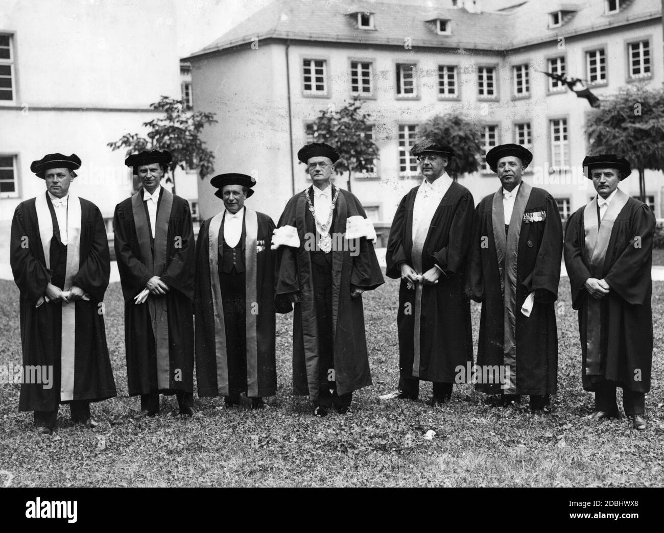 Rector Professor Wilhelm Groh (centre with Rector' s medal) with the deans of the Ruprecht Karl University Heidelberg from left to right: Prof. Eduard Boetticher, Prof. Karl Engisch, Prof. Odenwald, Wilhelm Grohe, Prof. Hermann Guentert, Prof. Carl Schneider and Prof. Heinrich Vogt. Stock Photo