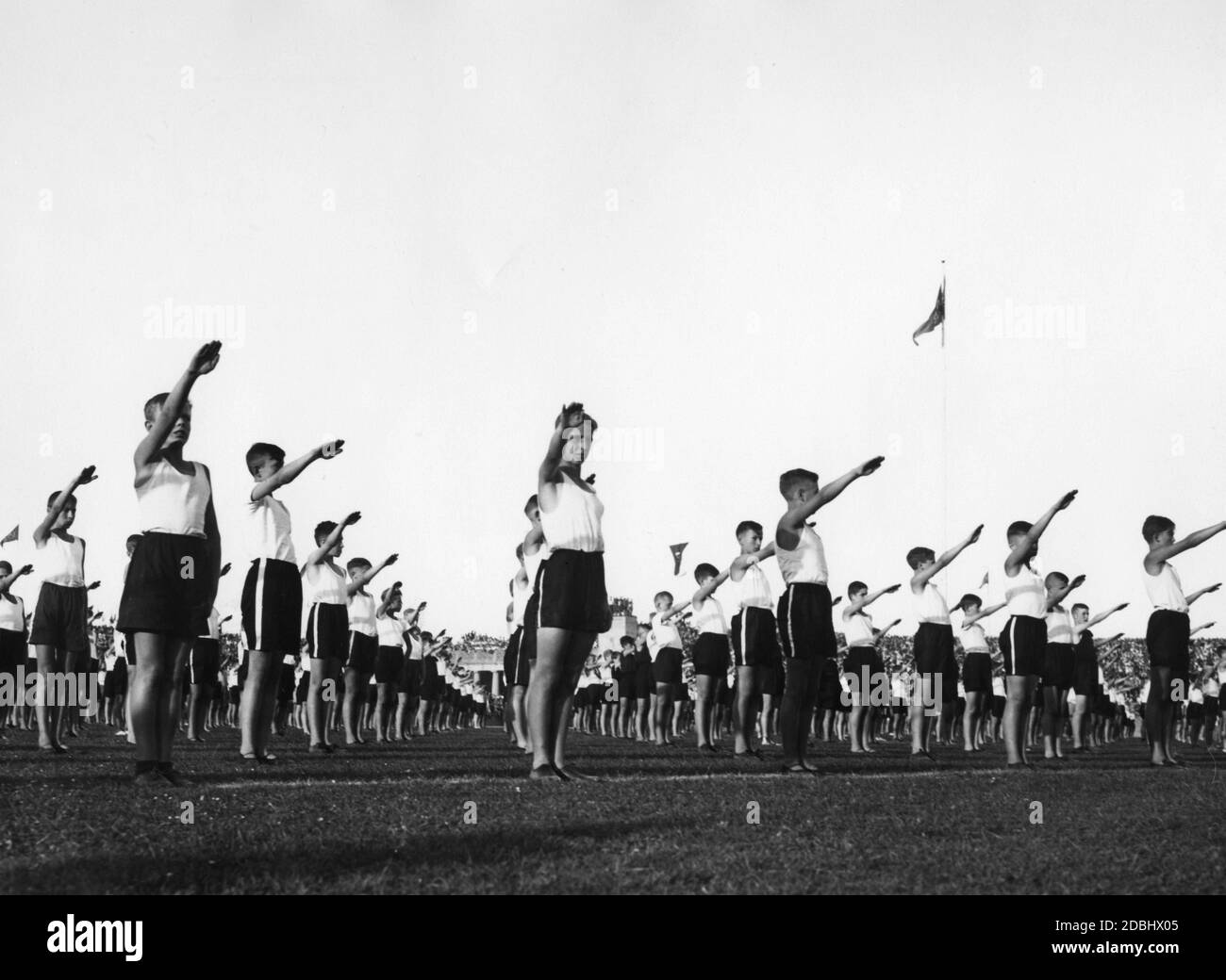 'In the Deutsches Stadion of Berlin at the ''Fest der Deutschen Schule'' (Festival of the German School), 10-year-old boys in rank and file greet with the Hitler salute in front of 30,000 spectators.' Stock Photo