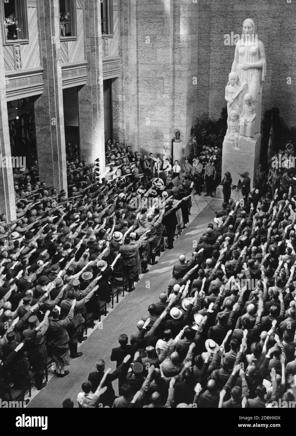 'The ''Haus der Deutschen Erziehung'' (House of German Education) is solemnly inaugurated by Reichswalter Fritz Waechtler of the NSLB, at the national conference of the National Socialist Teachers League in Bayreuth. In honour of the deceased Hans Schemm, the festival assembly sings the song ''Der gute Kamerad'' (The Good Comrade) by Ludwig Uhland. In the middle of the Hall of Honour for the German Mother is the statue of the German Mother.' Stock Photo