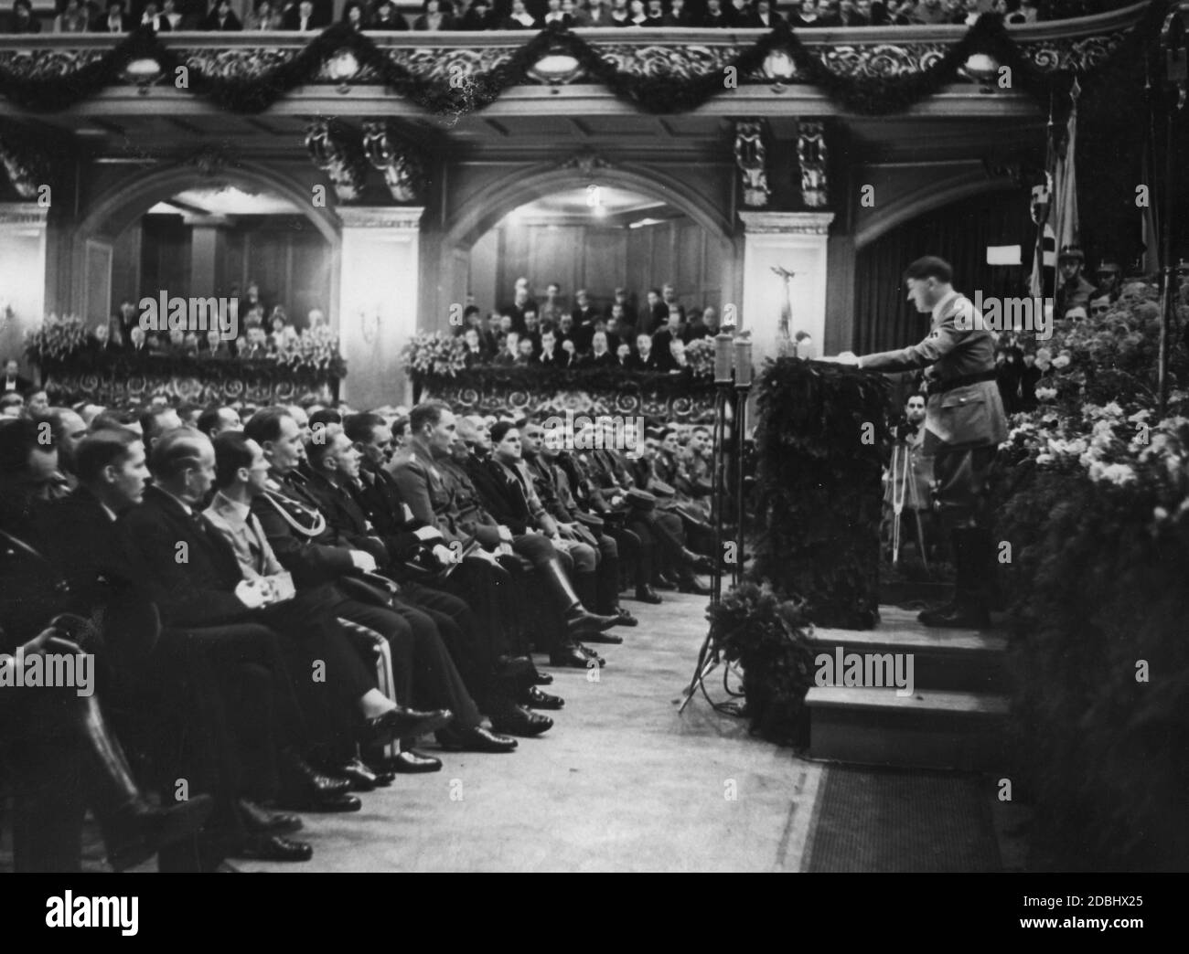 At the proclamation of the constitutions of the Deutsche Studentenschaft (German Student Union) and the Deutsche Fachschulschaft (German Technical Students' Union) by Wilhelm Frick in the Philharmonie, Adolf Hitler gives a speech to the German academic community. Delegations from Berlin and other German colleges, universities and technical colleges, the rectors of all German colleges and universities and representatives of the district administrations and local groups of the NSDStB attended the event. In the 1st row from left  Johann Ludwig Graf Schwerin von Krosigk, Paul Eltz von Ruebenach, Stock Photo
