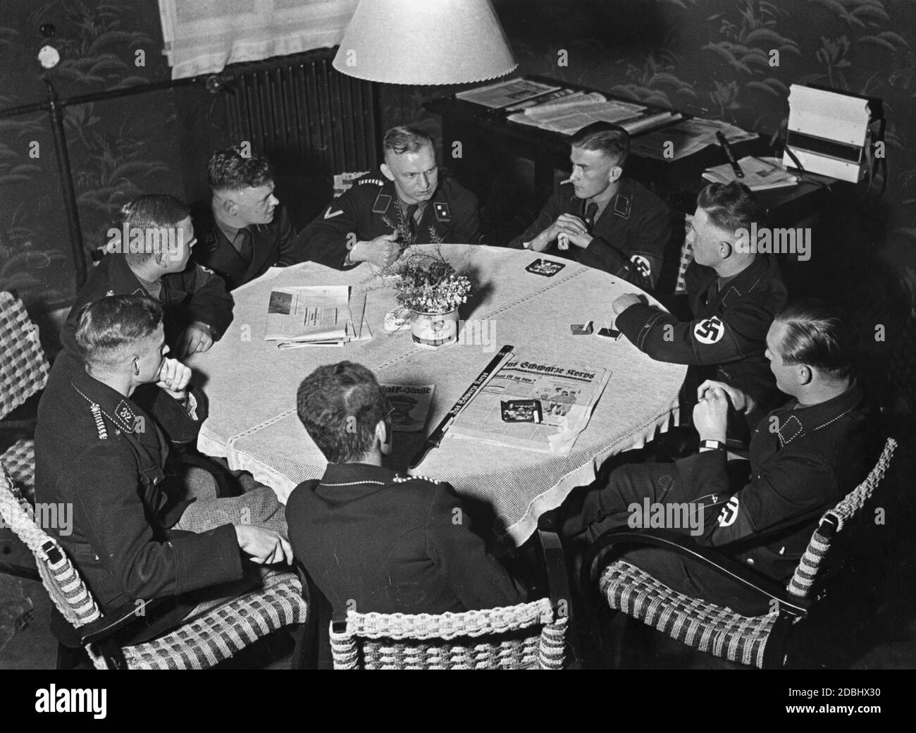'Members of the SS-Student Company at the University of Heidelberg in their team house. On the table is the newspaper ''Das schwarze Korps''.' Stock Photo