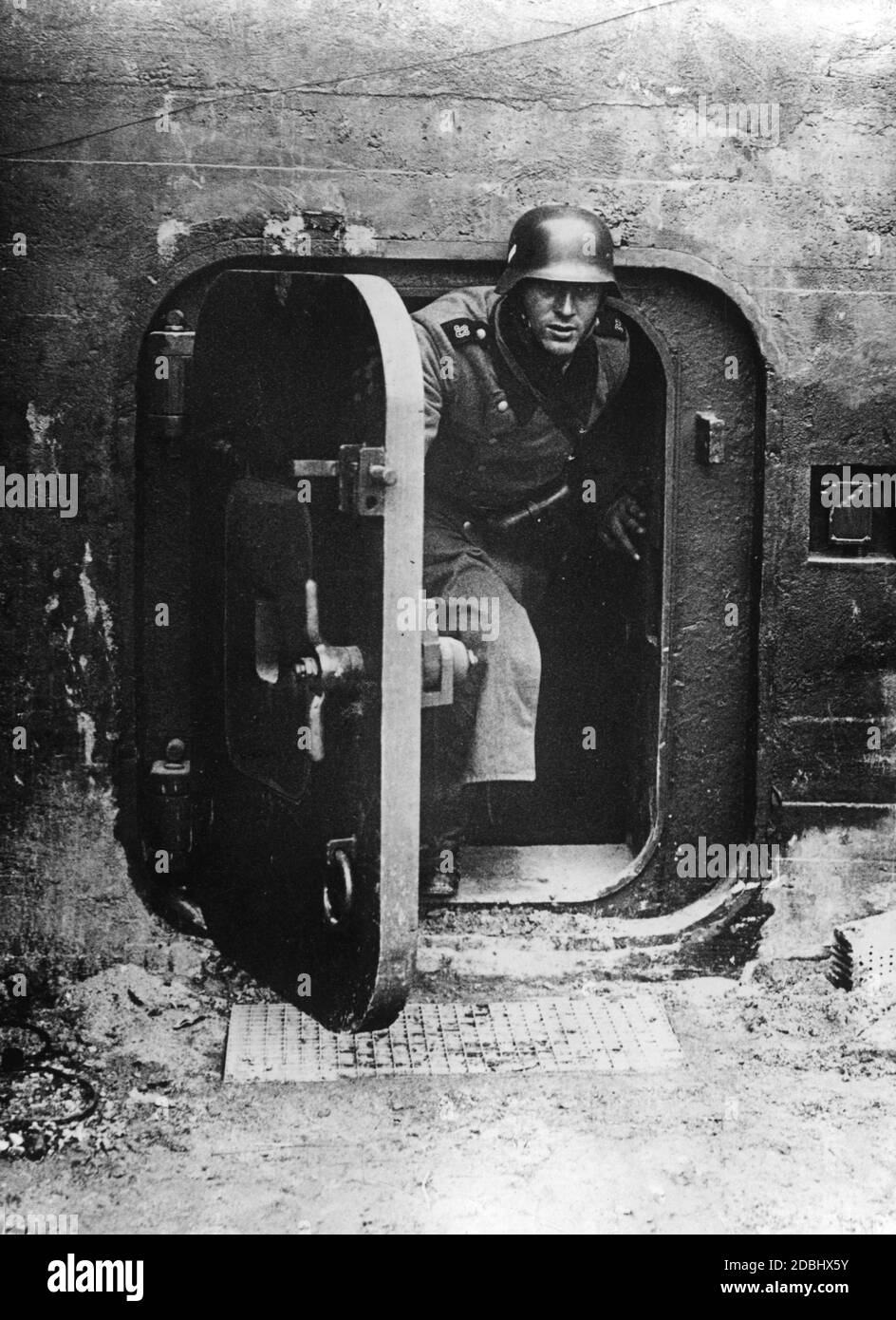 'This photograph of a Wehrmacht soldier in a bunker on the Siegfried Line was published in several German newspapers. The reports on the ''Siegfried Line'' were intended to reduce the population's fear regarding an imminent war on two fronts.' Stock Photo