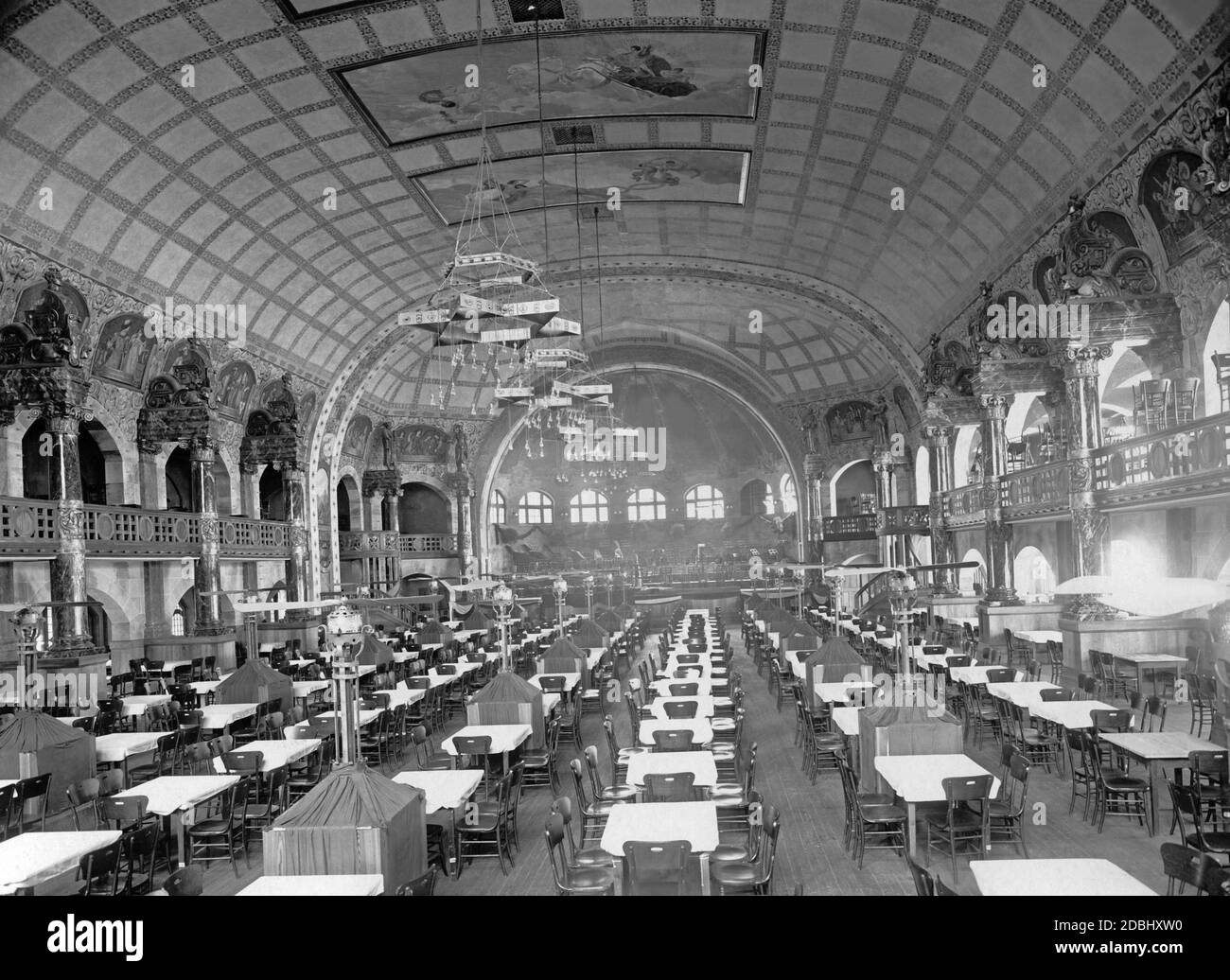 'The Knights' Hall in the ''German-Tyrolean Alps'' at the St. Louis World's Fair (Louisiana Purchase Exposition). In the foreground are rows of tables, in the background the orchestra stage.' Stock Photo