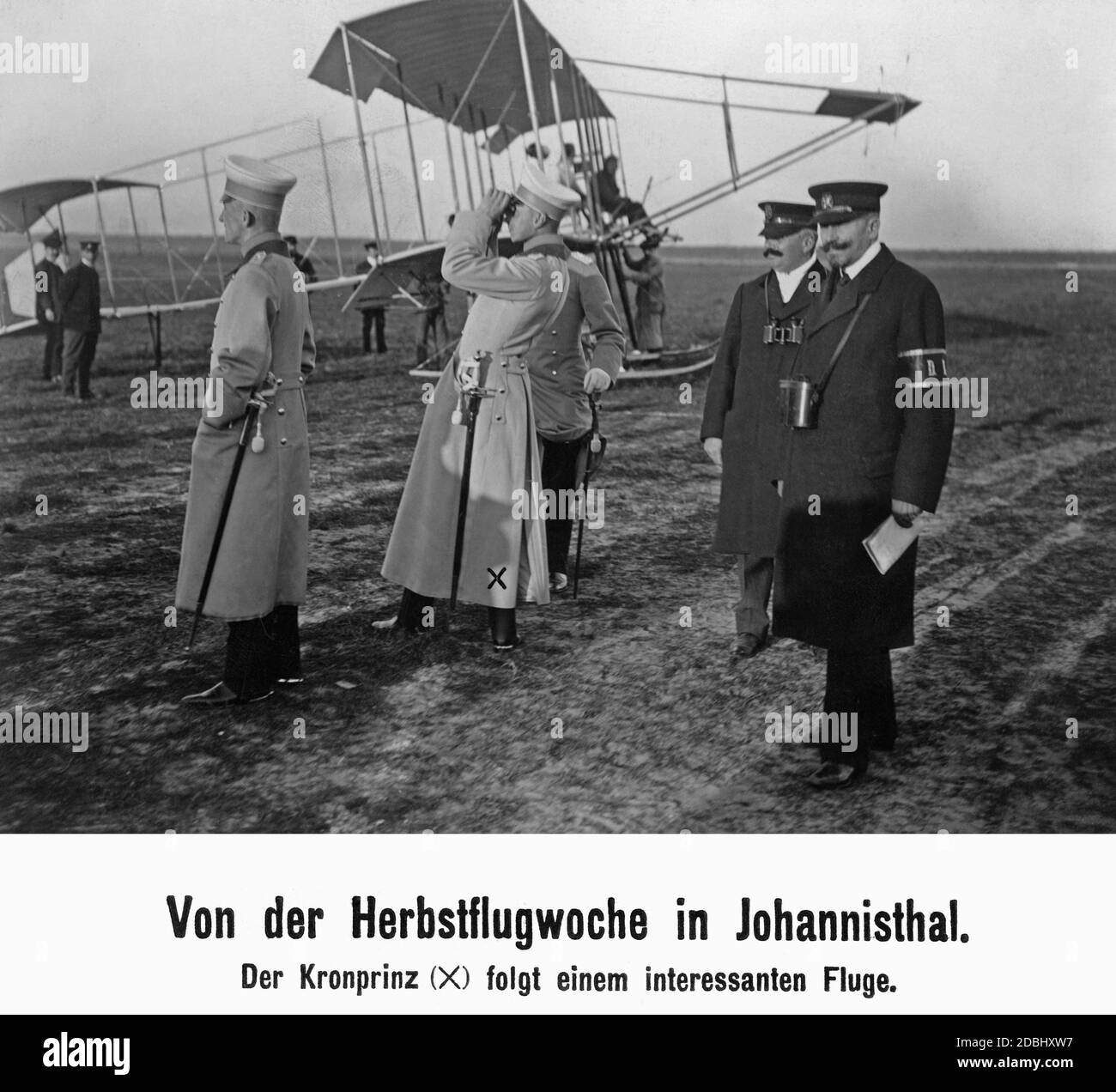 The German Crown Prince observes with binoculars a flight during the Flight Week at the Johannisthal airfield. Stock Photo