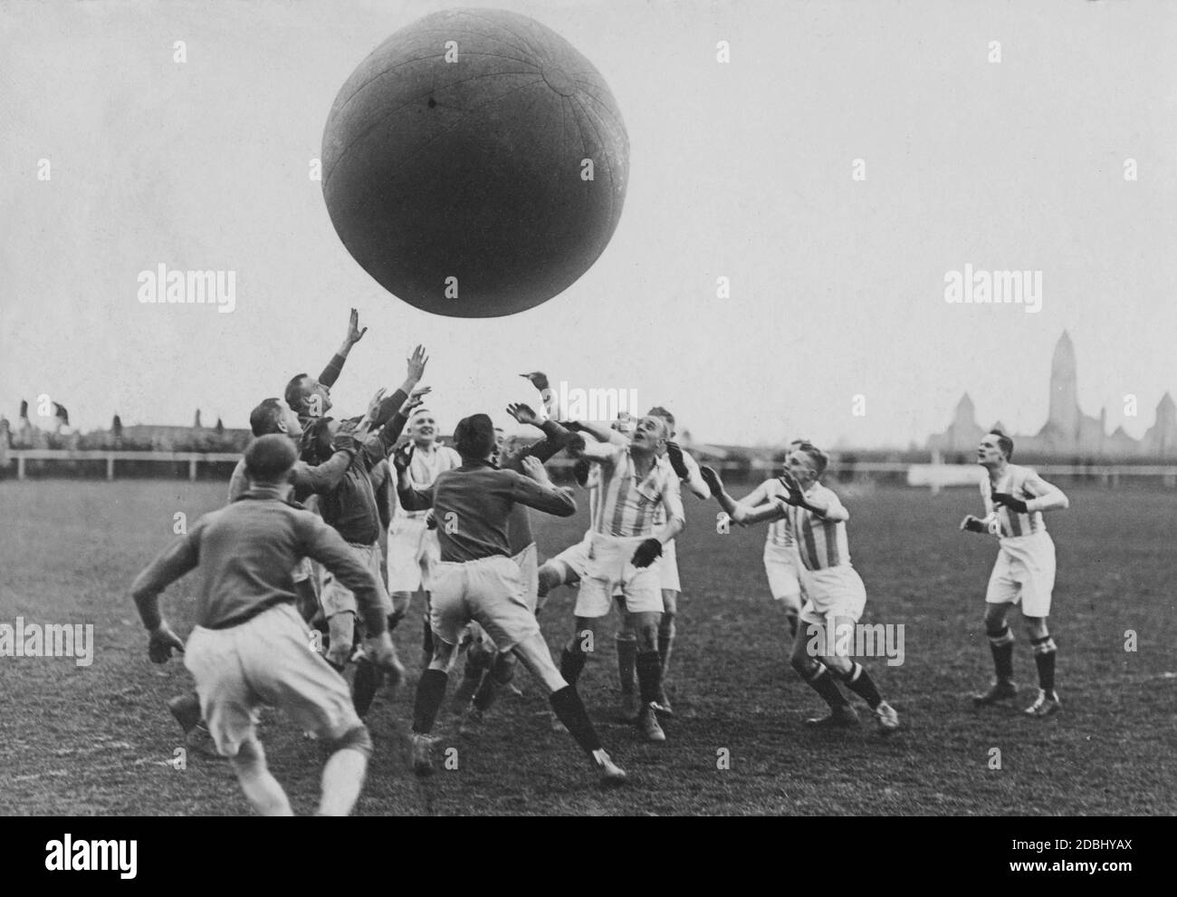 In a pushball competition Leipzig plays against Halle. A 1.8 meter high and 23 kg heavy ball is to be brought into the opponent's goal, whereby almost all techniques are allowed. The men hold the ball high in the air. Stock Photo