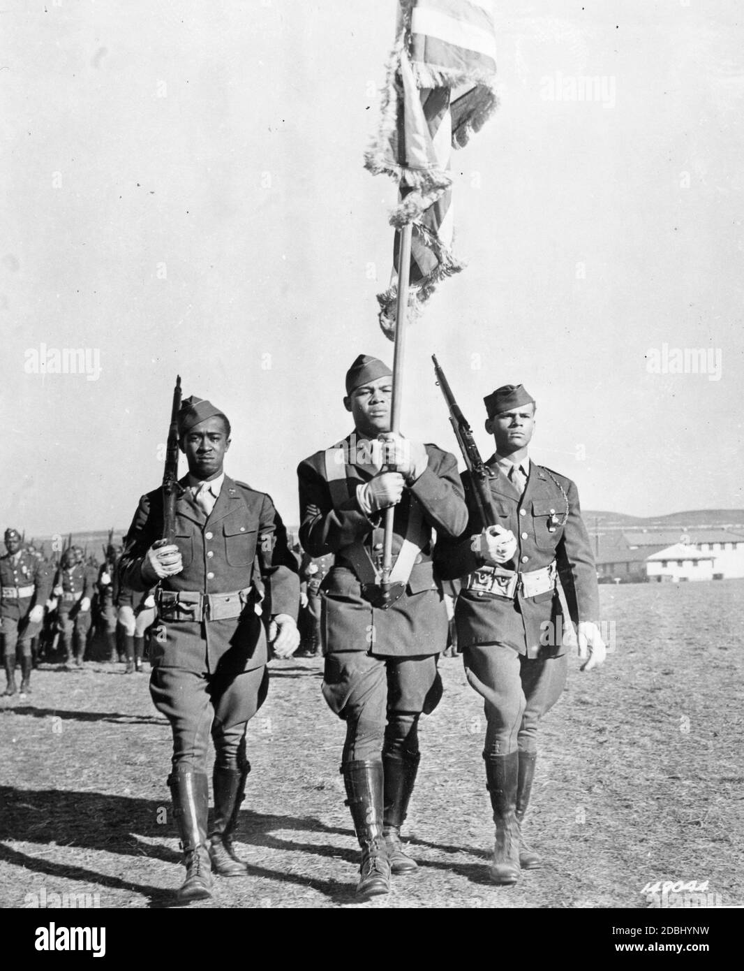 The US Army's 8th Training Squadron parades in review, with boxer Sgt Joe Louis Barrow, known professionally as Joe Louis, carrying the colors, Fort Riley, KS, 11/1942. (Photo by US Army Signal Corps/RBM Vintage Images) Stock Photo