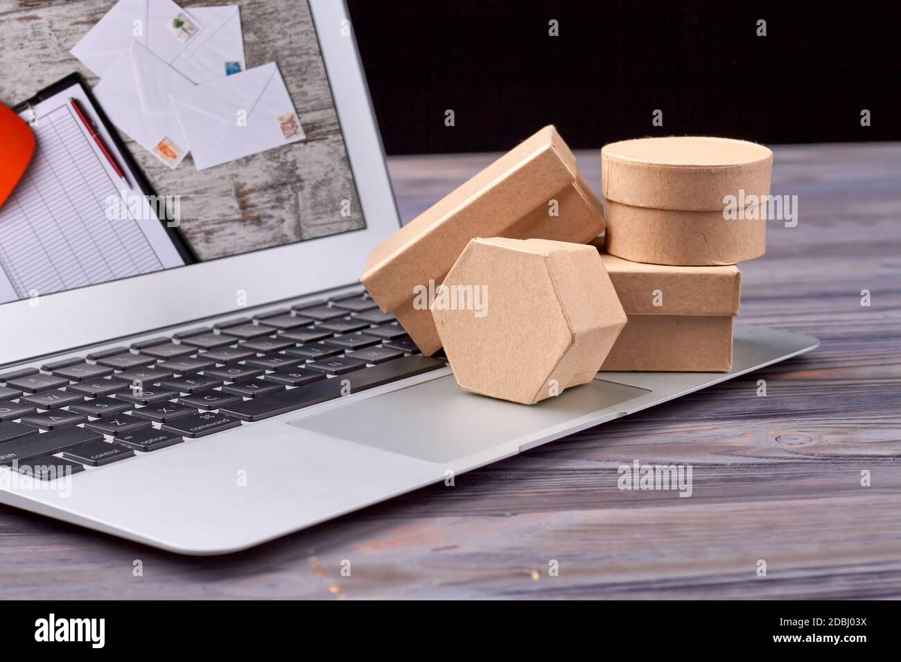 Packaging paper and shipping boxes on laptop. Stock Photo