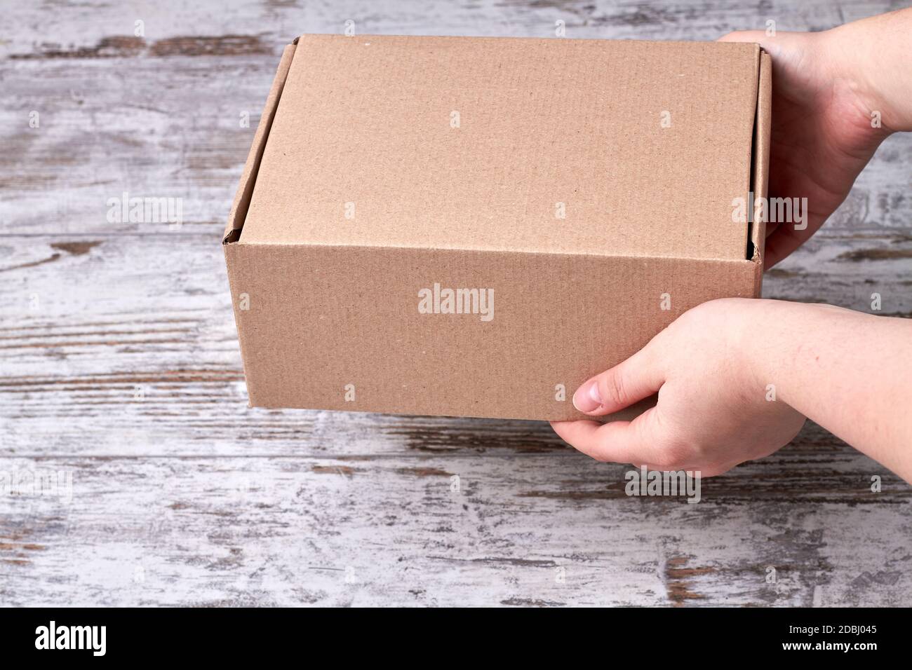 Cardboard box in hands Stock Photo - Alamy