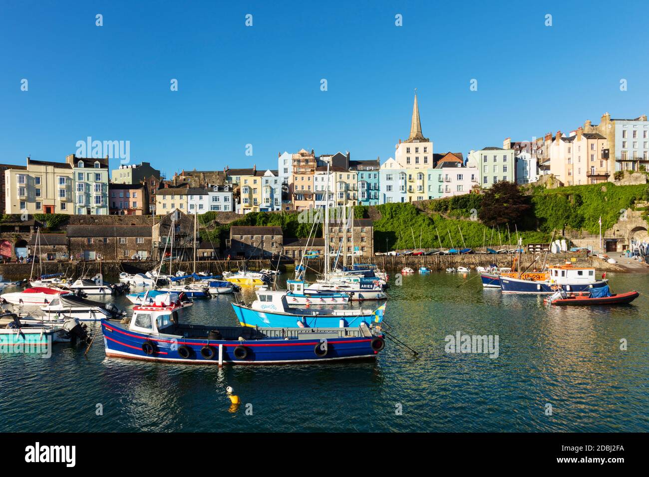 View of the town centre and fishing boats in the harbour, Tenby, Pembrokeshire, Wales, United Kingdom, Europe Stock Photo