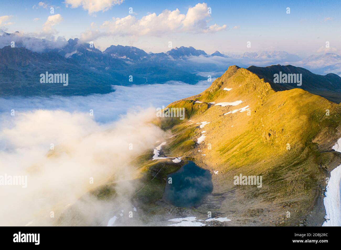 Schwarziseeli lake and Stotzigen Firsten mountain emerging from a sea of clouds, aerial view, Furka Pass, Canton Uri, Switzerland, Europe Stock Photo