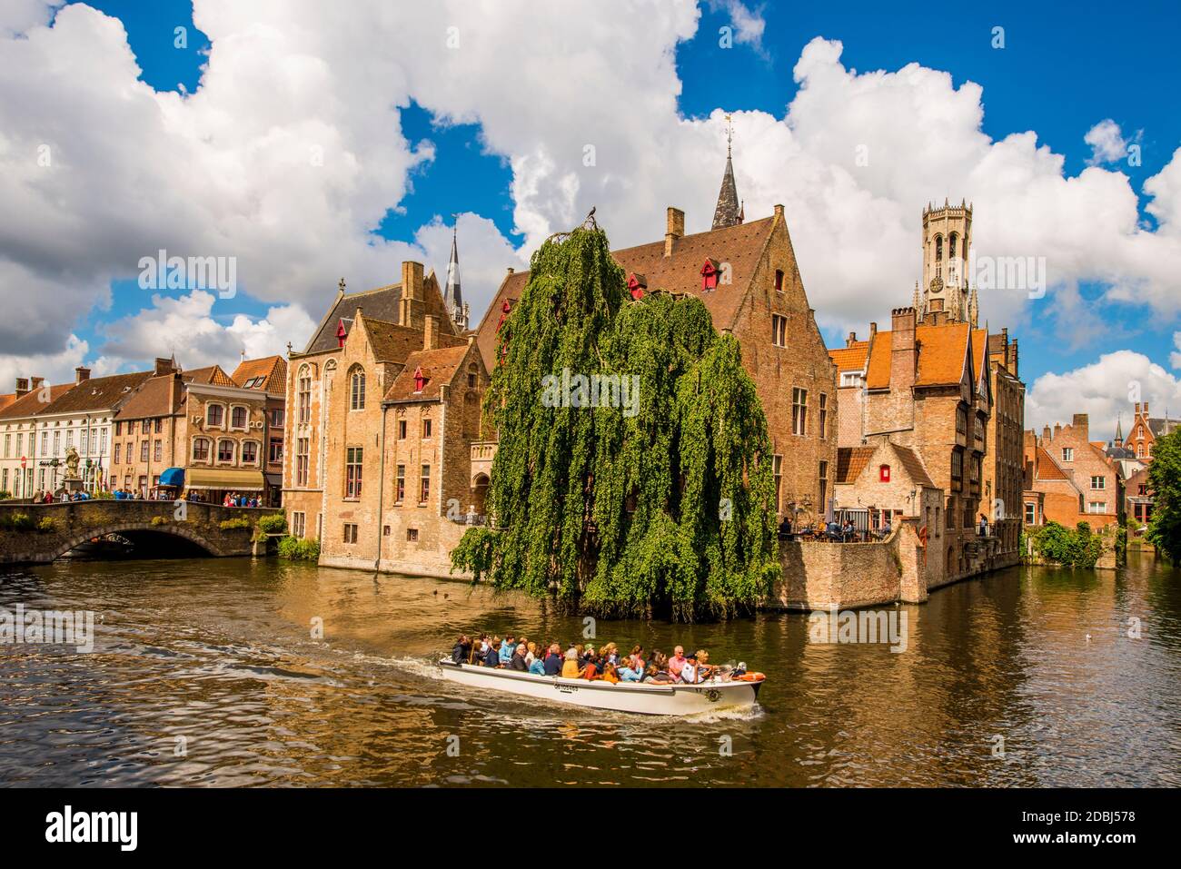 Tour boat on Rozenhoedkaai canal with Belfort tower, Bruges, UNESCO World Heritage Site, West Flanders, Belgium, Europe Stock Photo