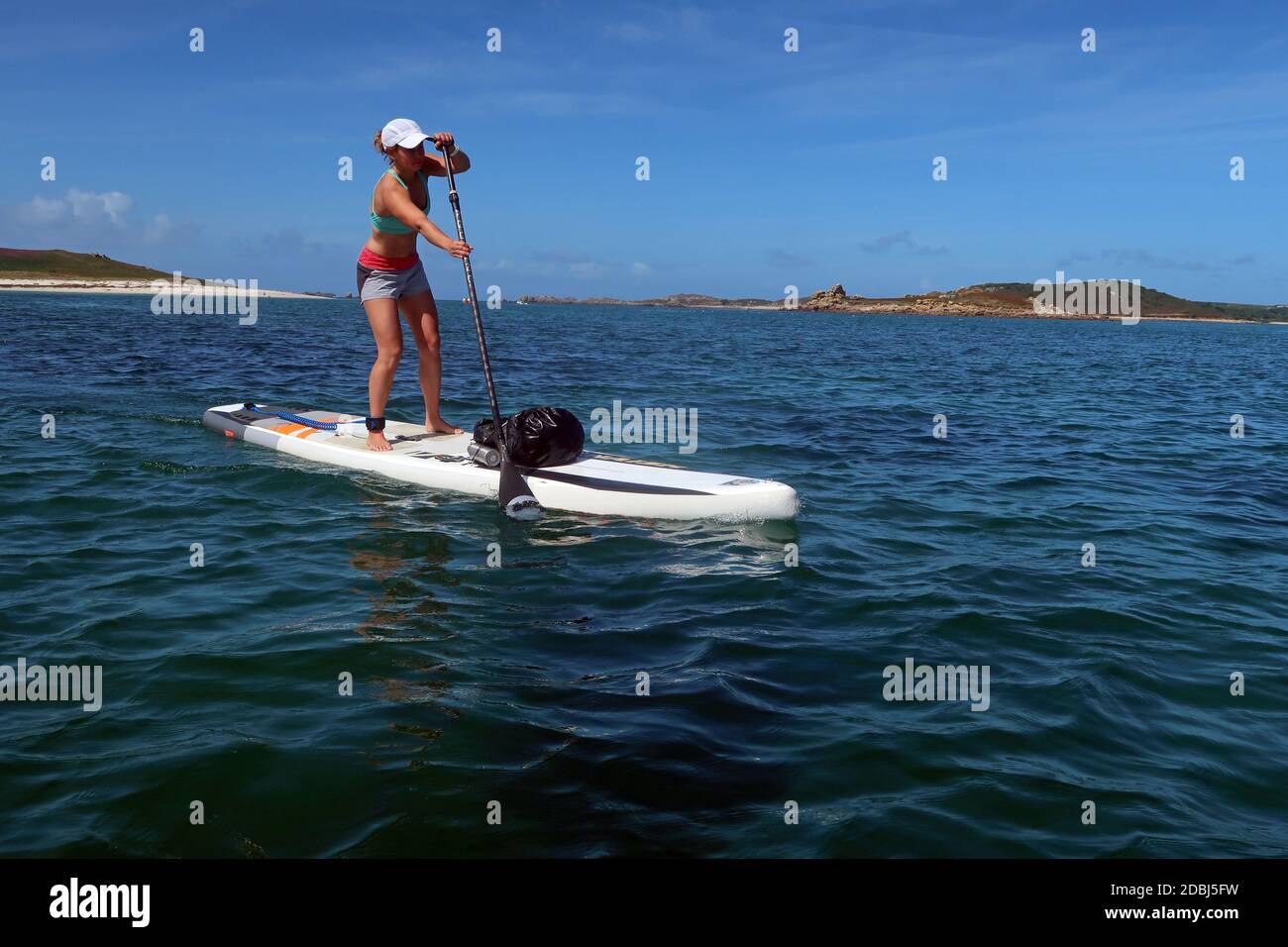 Paddle boarder crossing from Bryher to St. Mary's, Isles of Scilly, England, United Kingdom, Europe Stock Photo