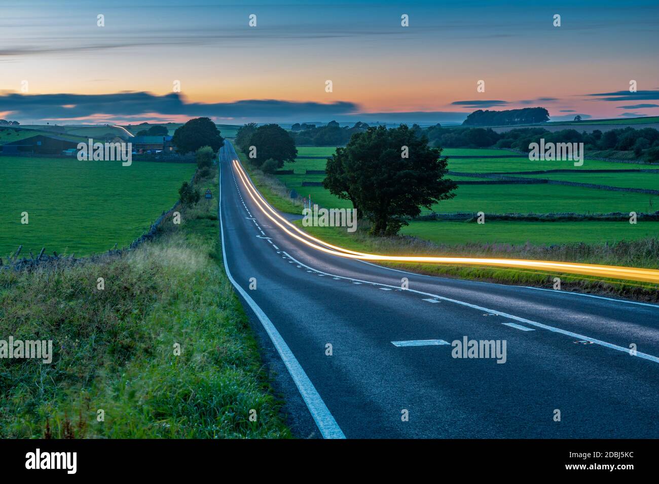 View of trail lights on the A515 near Newhaven at dusk, Peak District National Park, Derbyshire, England, United Kingdom, Europe Stock Photo