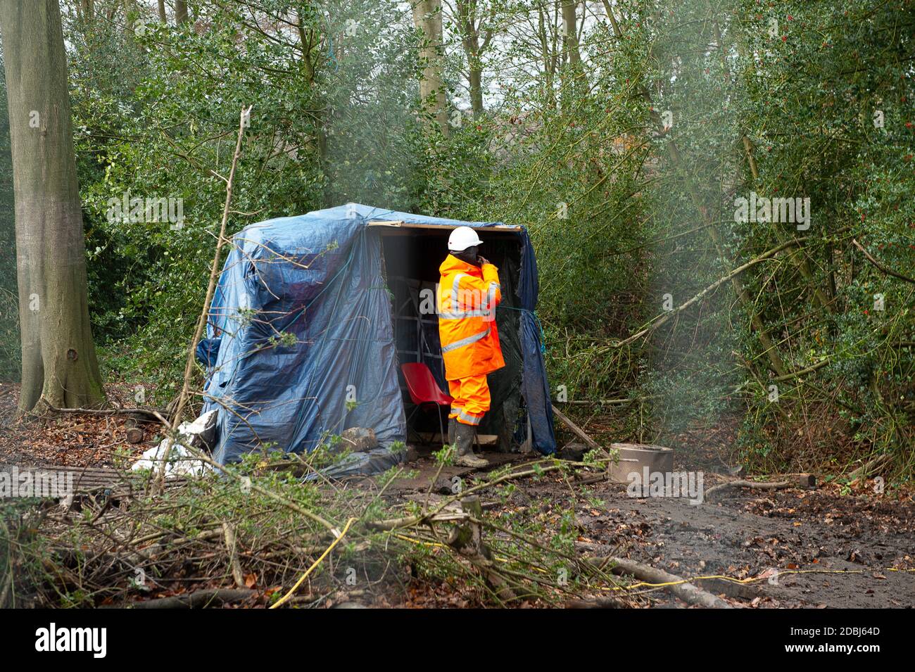 Aylesbury Vale, Buckinghamshire, UK. 17th November, 2020. HS2 have already destroyed ground cover in the woods. One of many HS2 security guards the woodland. The Woodland Trust have issued a press release asking for an immediate pause on work at the wood to said that they have “grave concerns” that ancient woodland due for imminent destruction by HS2 Ltd might be felled without proper survey work to identify bat roosts, and without the proper licences required by law. Credit: Maureen McLean/Alamy Live News Stock Photo